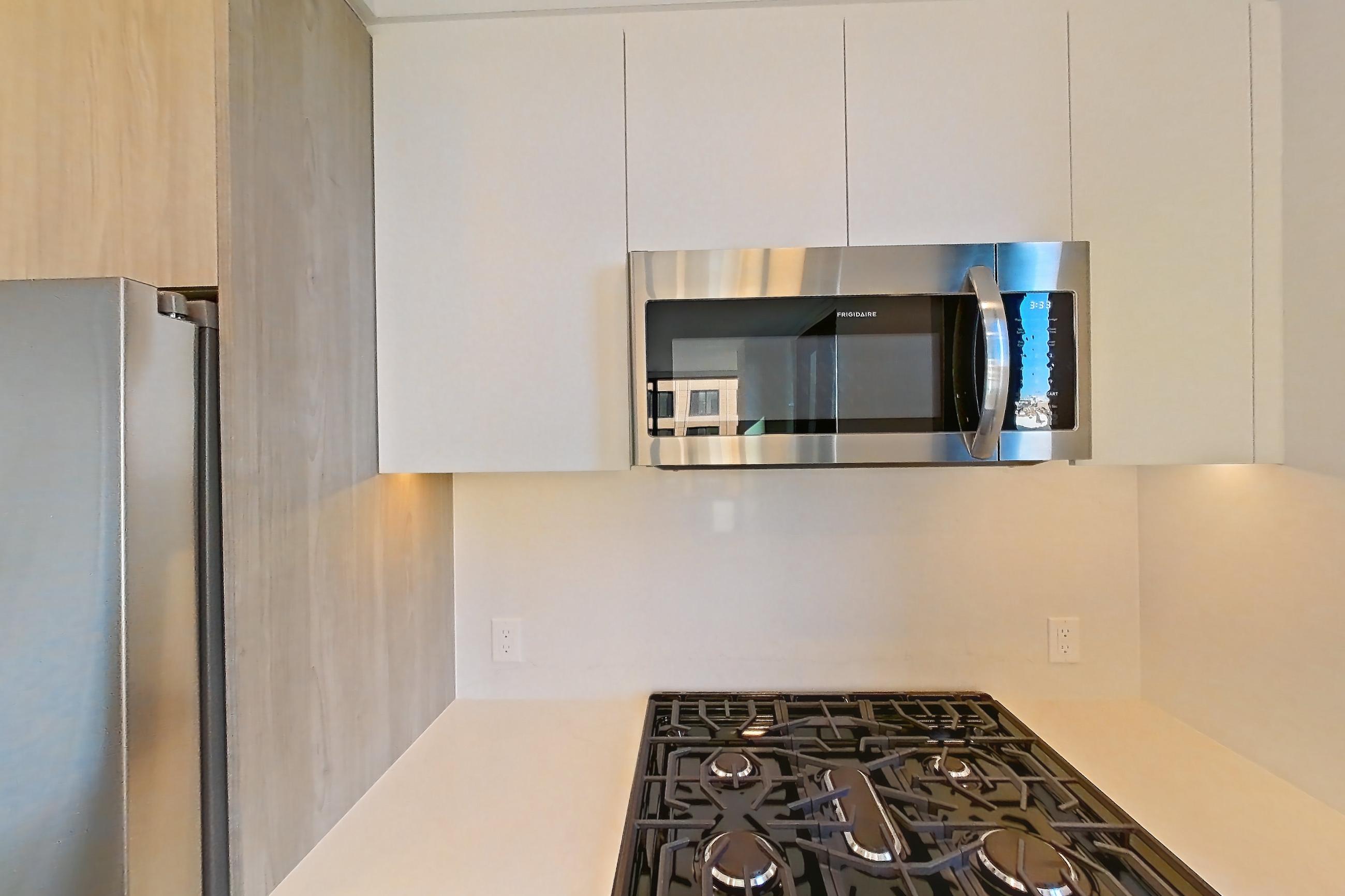 Kitchen with gas range, light wood-finish flooring, oven/range, and stainless steel appliances, Apartment 738 at Loden