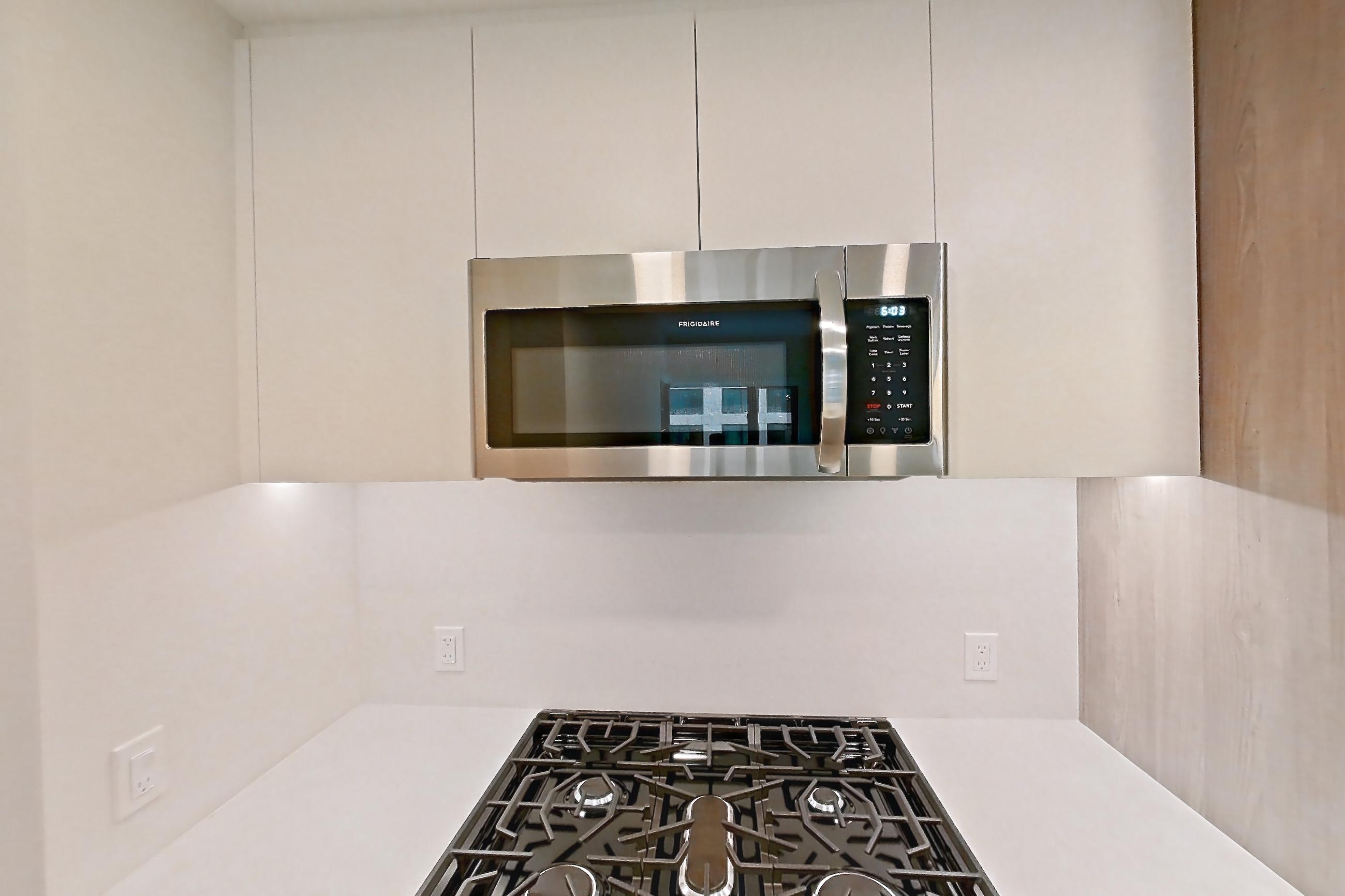 Kitchen with gas range, light wood-finish flooring, oven/range, and stainless steel appliances, Apartment 0931 at Loden