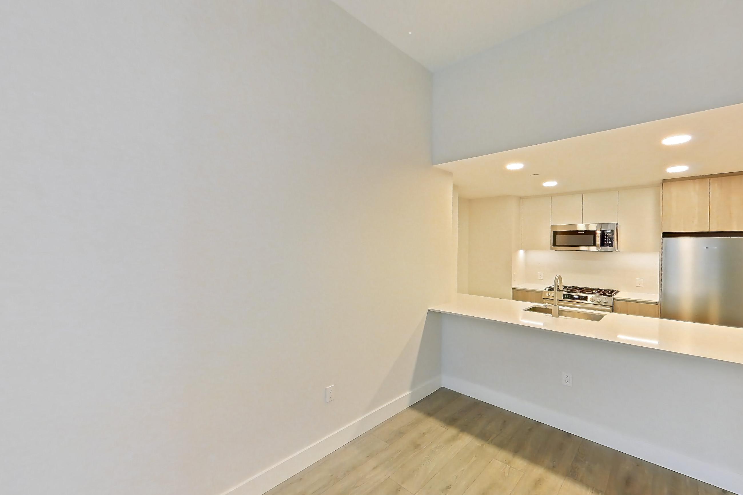 Living room with light wood-finish flooring, Apartment 0931 at Loden