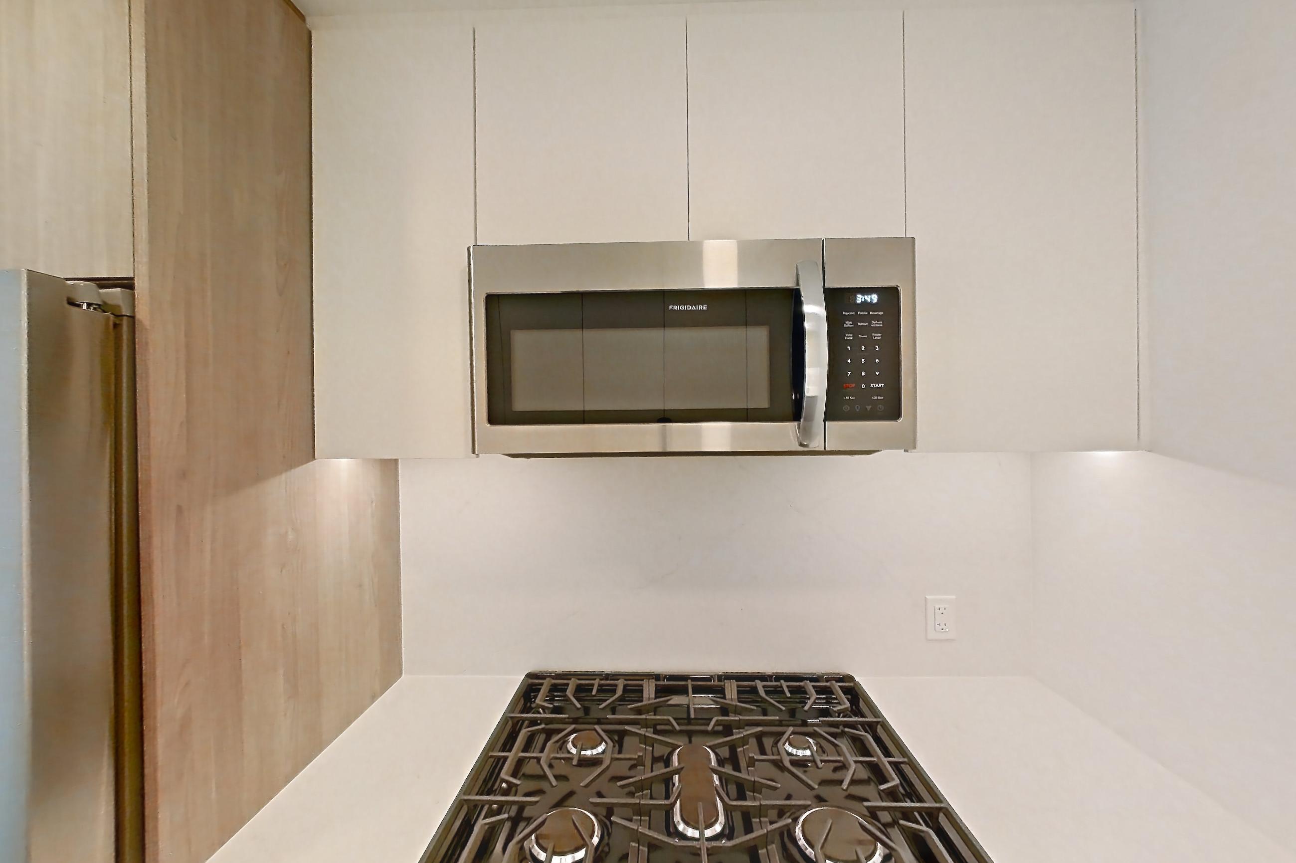 Kitchen with gas range, light wood-finish flooring, oven/range, and stainless steel appliances, Apartment 0937 at Loden