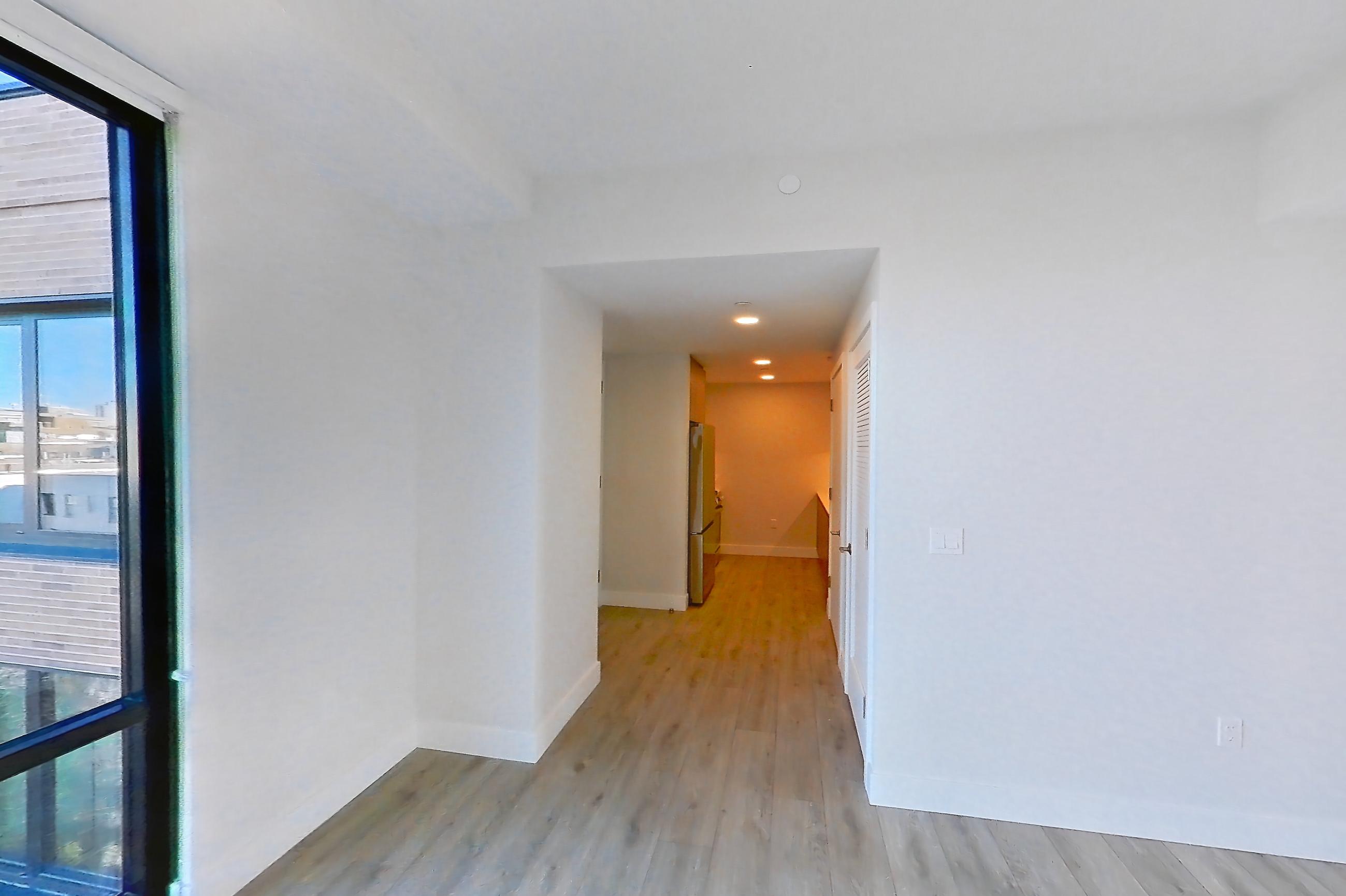 Living room with light wood-finish flooring, Apartment 0937 at Loden