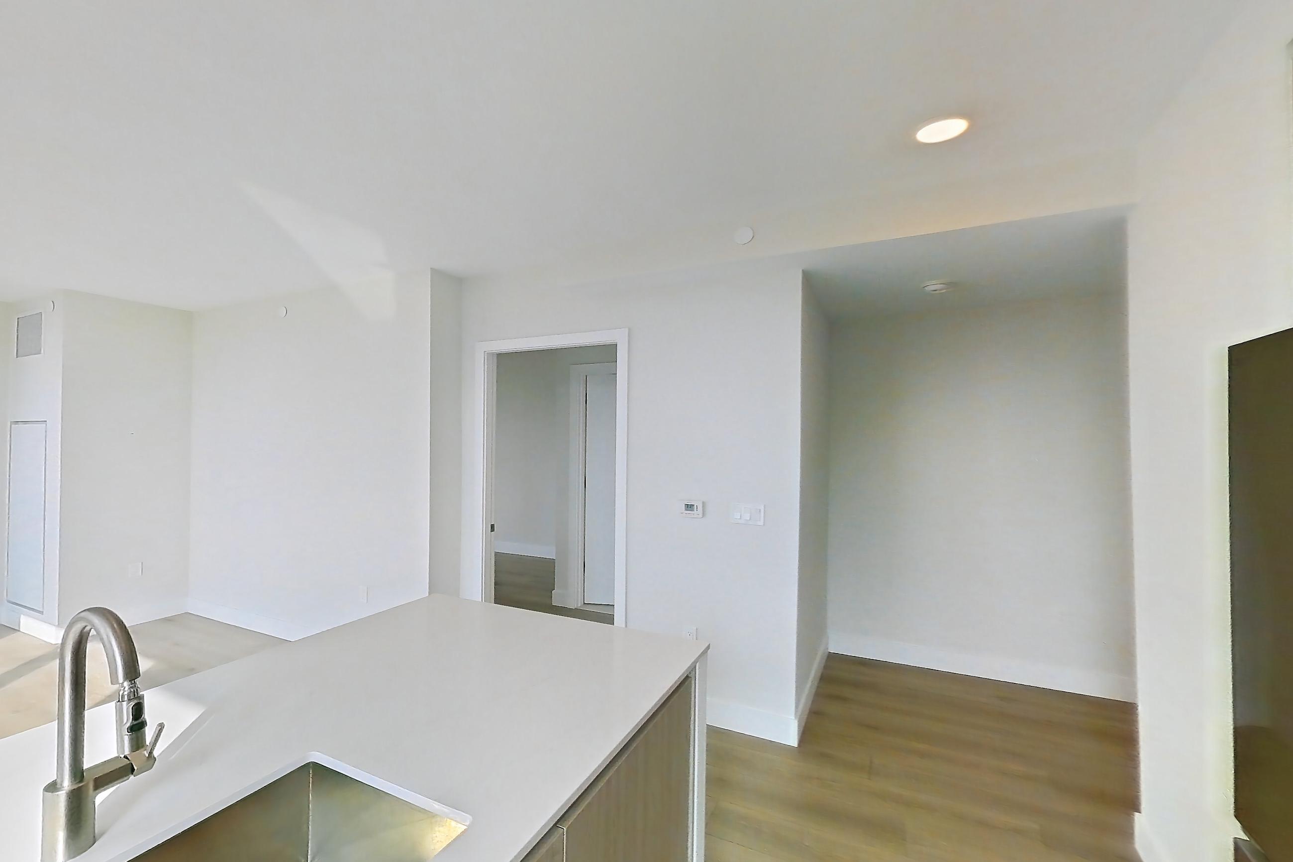 Kitchen with city view, gas range, light wood-finish flooring, oven/range, and stainless steel appliances, Apartment 1238 at Loden