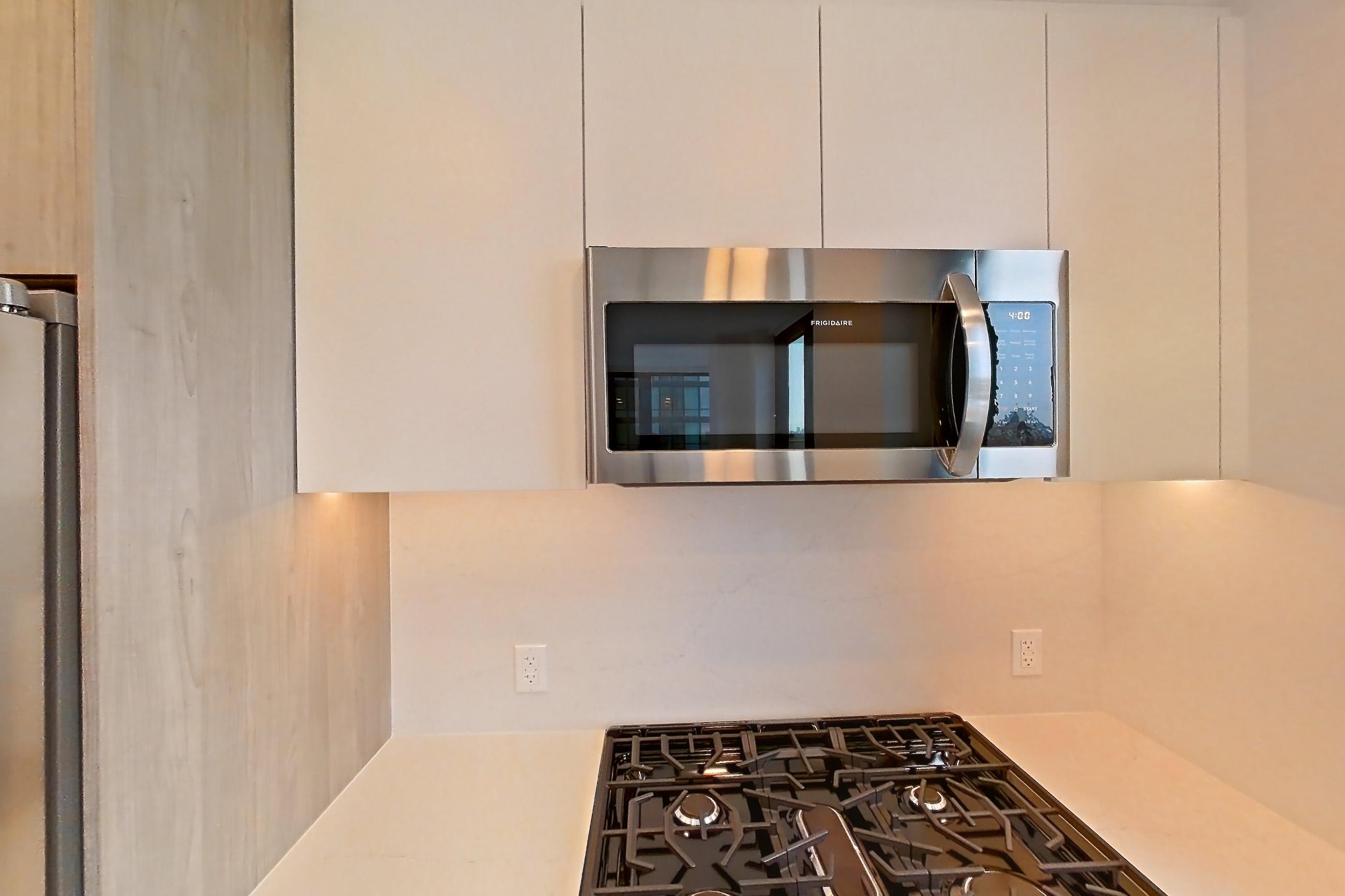 Kitchen with gas range, light wood-finish flooring, oven/range, and stainless steel appliances, Apartment 1338 at Loden
