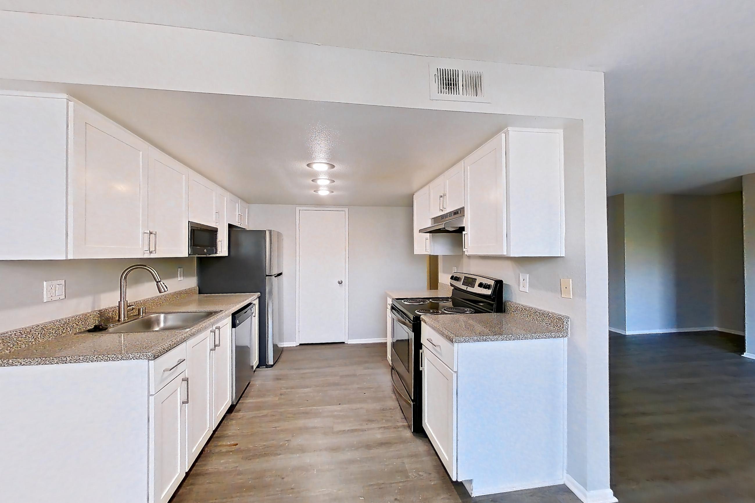 Dining space with dishwasher, electric range, light countertops, oven/range, refrigerator, and stainless steel appliances, Apartment 09 at Avana Rancho Cucamonga