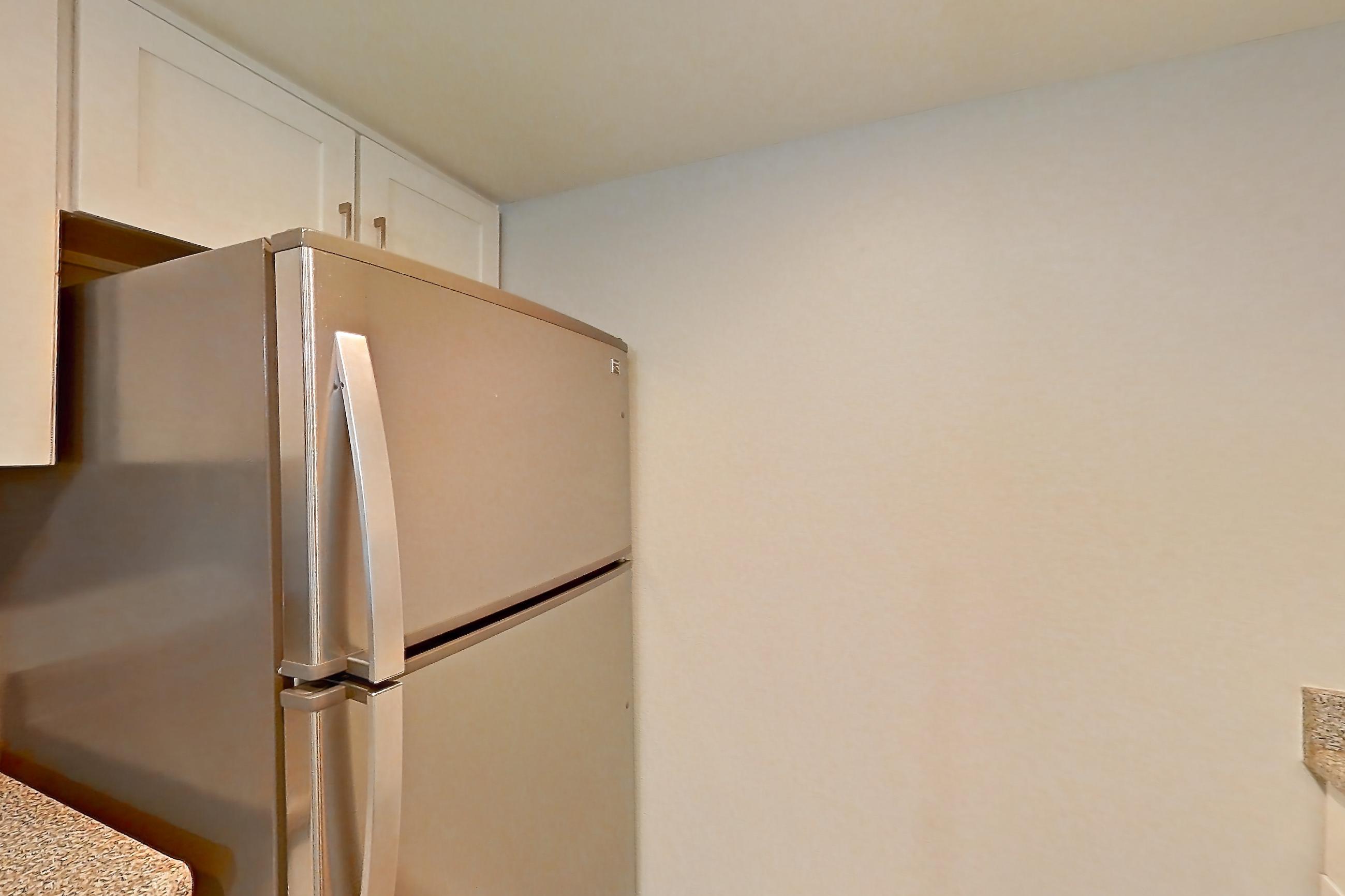 Kitchen with dishwasher, electric range, light countertops, light stone countertops, light wood-finish flooring, oven/range, and stainless steel appliances, Apartment 13 at Avana Rancho Cucamonga