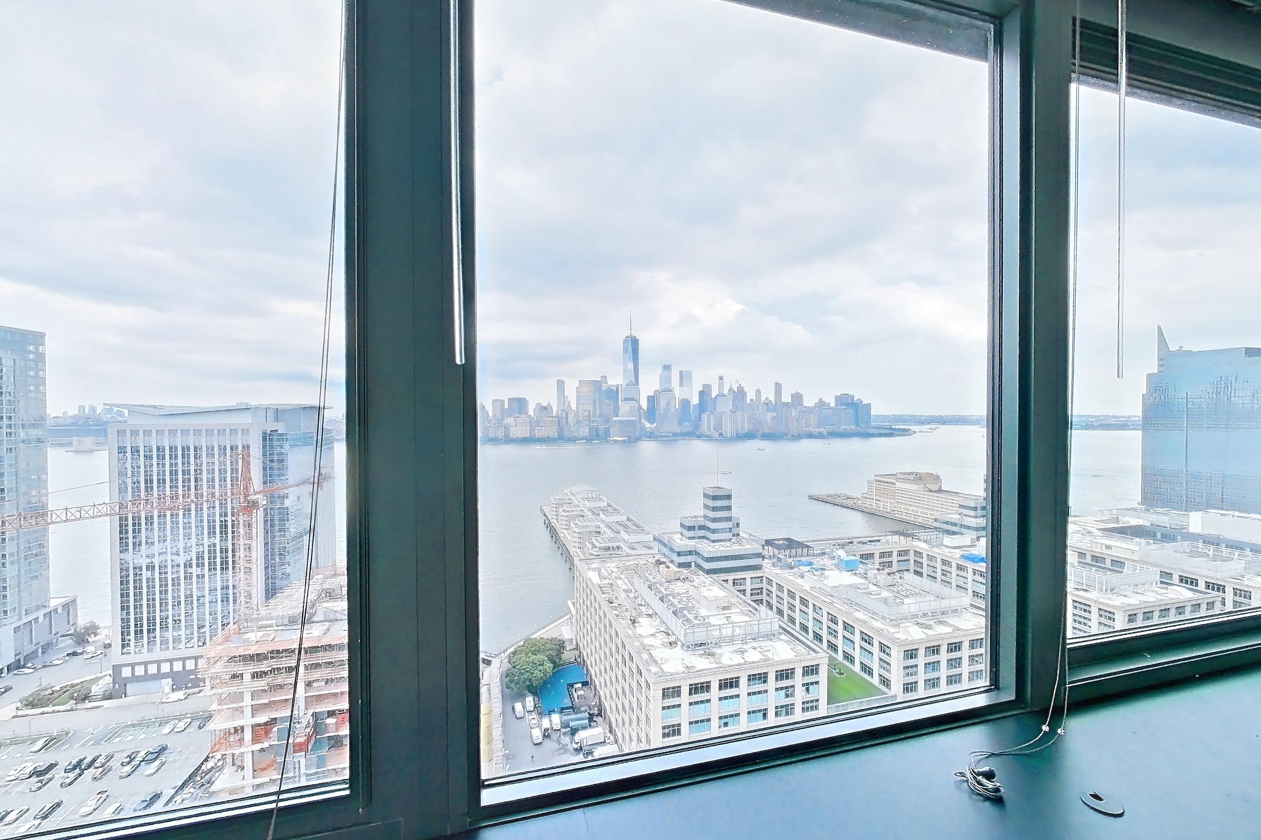 Living space with light wood-finish flooring, skyline view, and water view, Apartment SAB-3101 at Sable