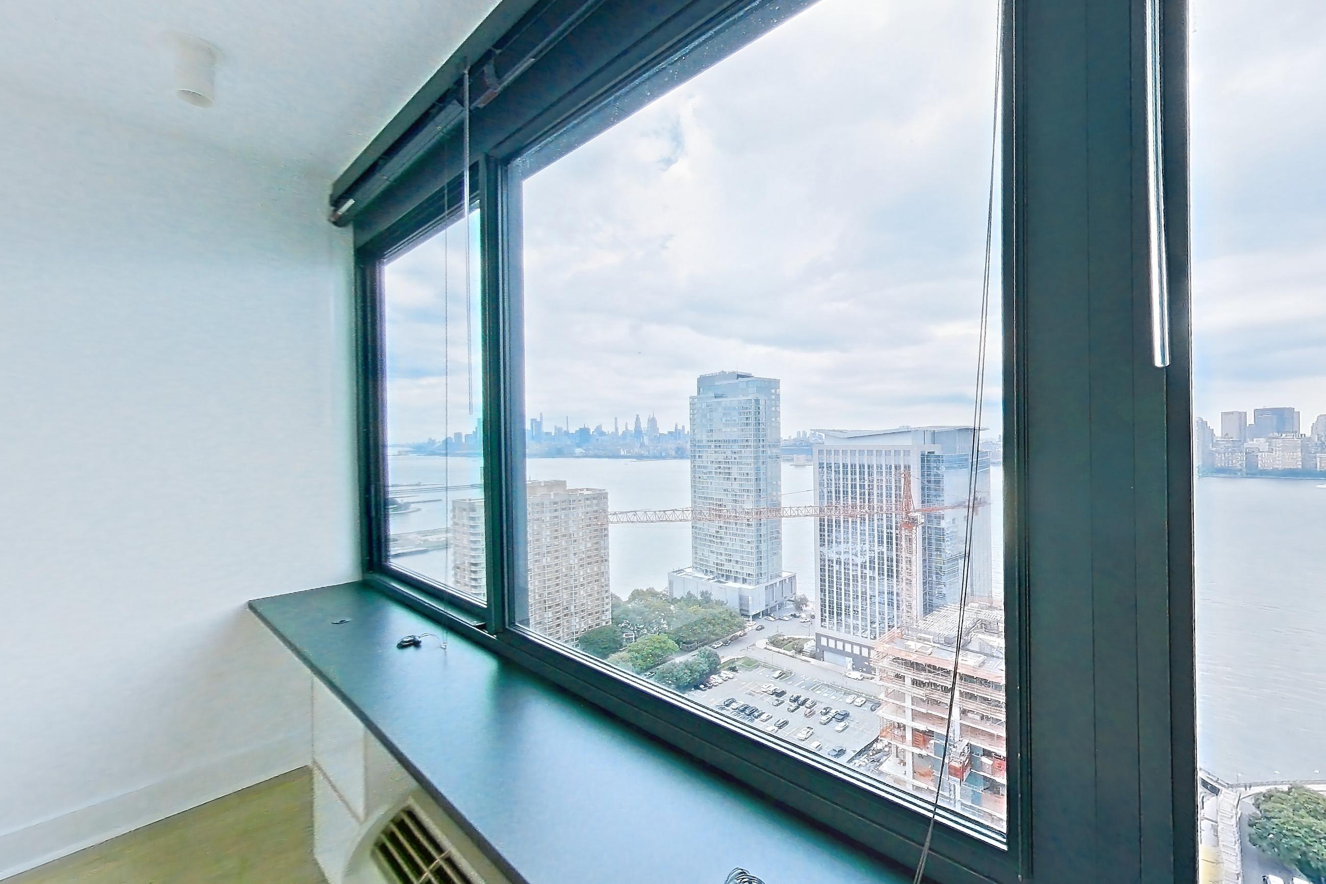 Living space with light wood-finish flooring, skyline view, and water view, Apartment SAB-3101 at Sable