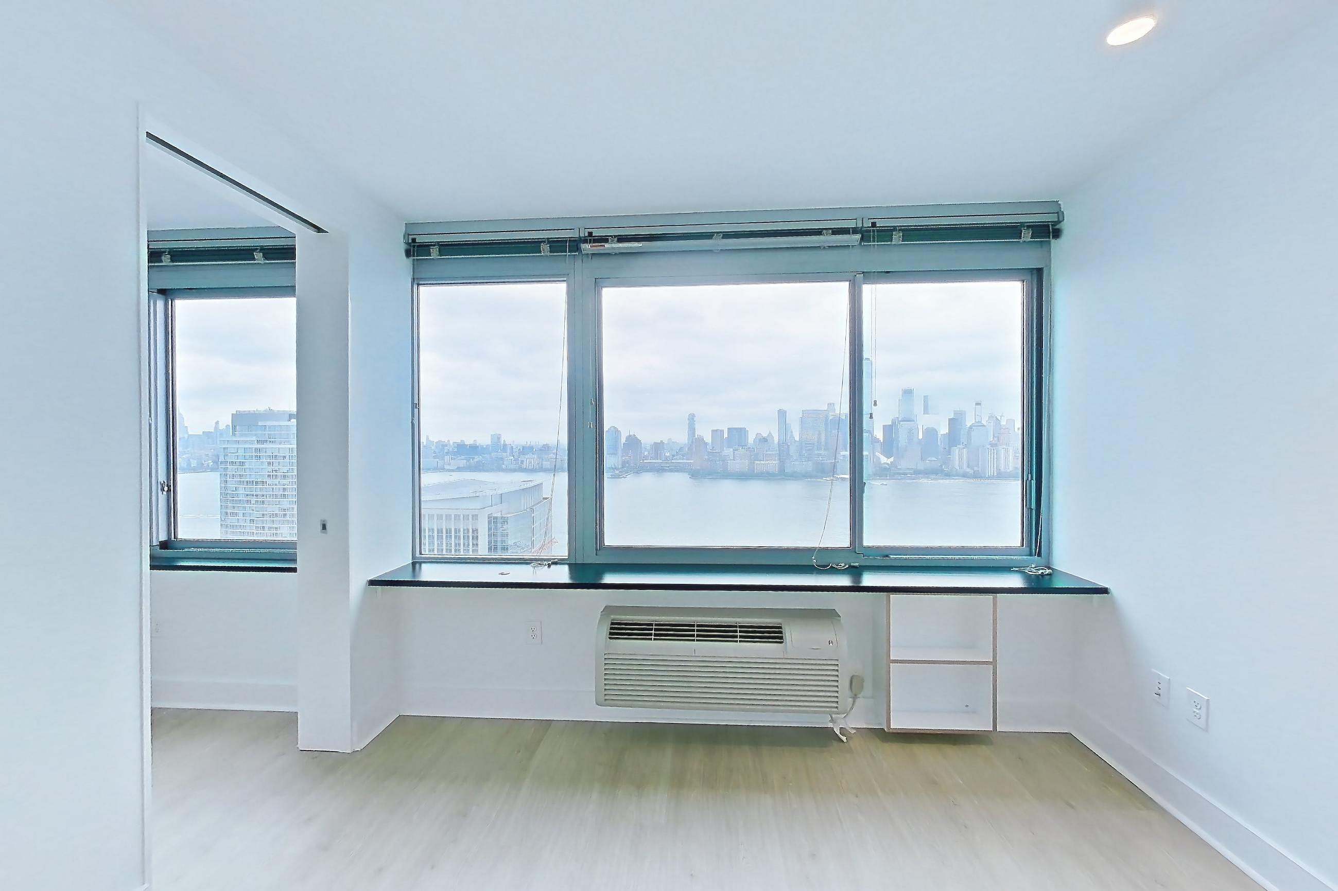 Living room with city view and light wood-finish flooring, Apartment SAB-3912 at Sable
