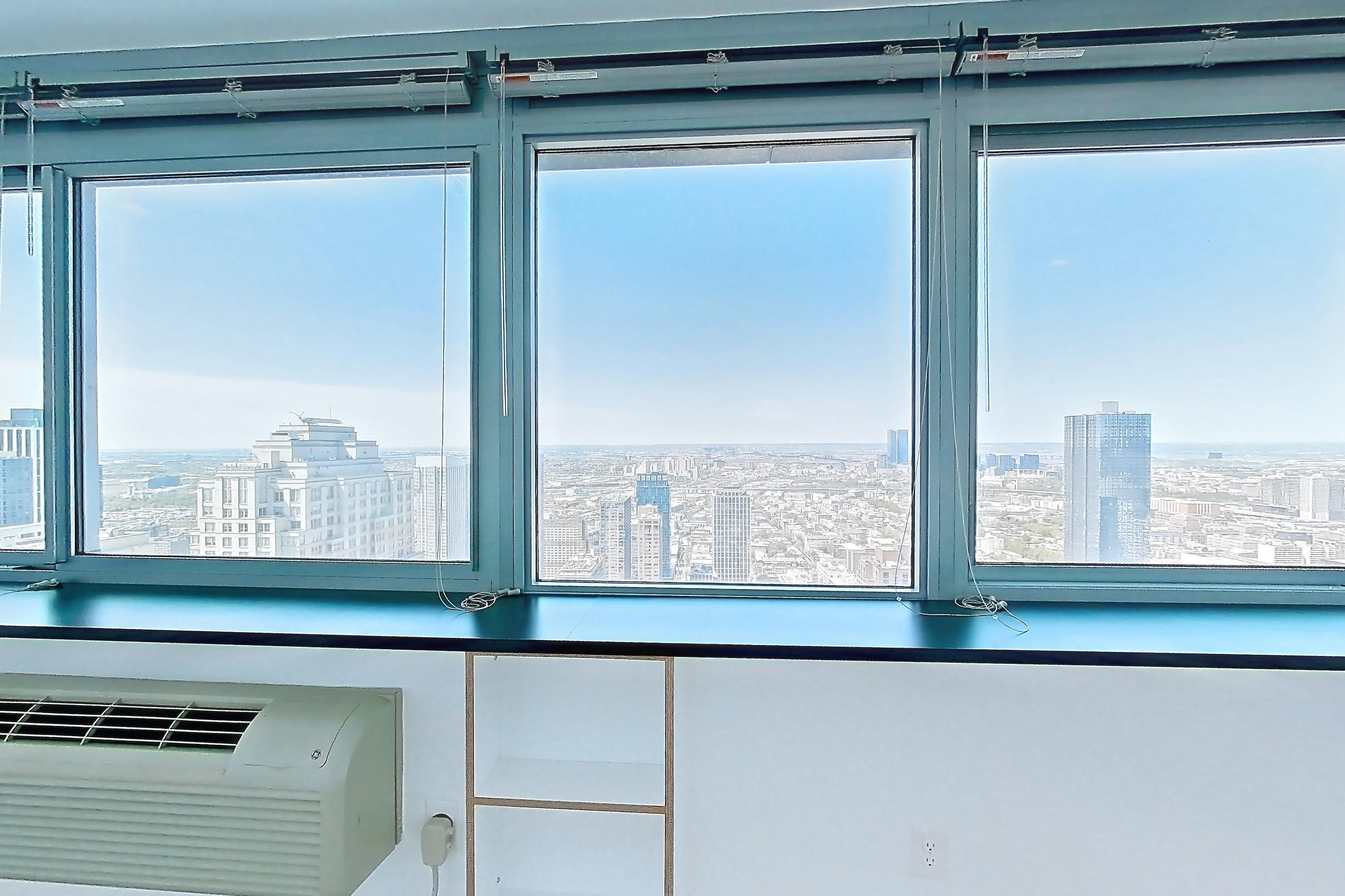 Living room with city view and light wood-finish flooring, Apartment SAB-5807 at Sable