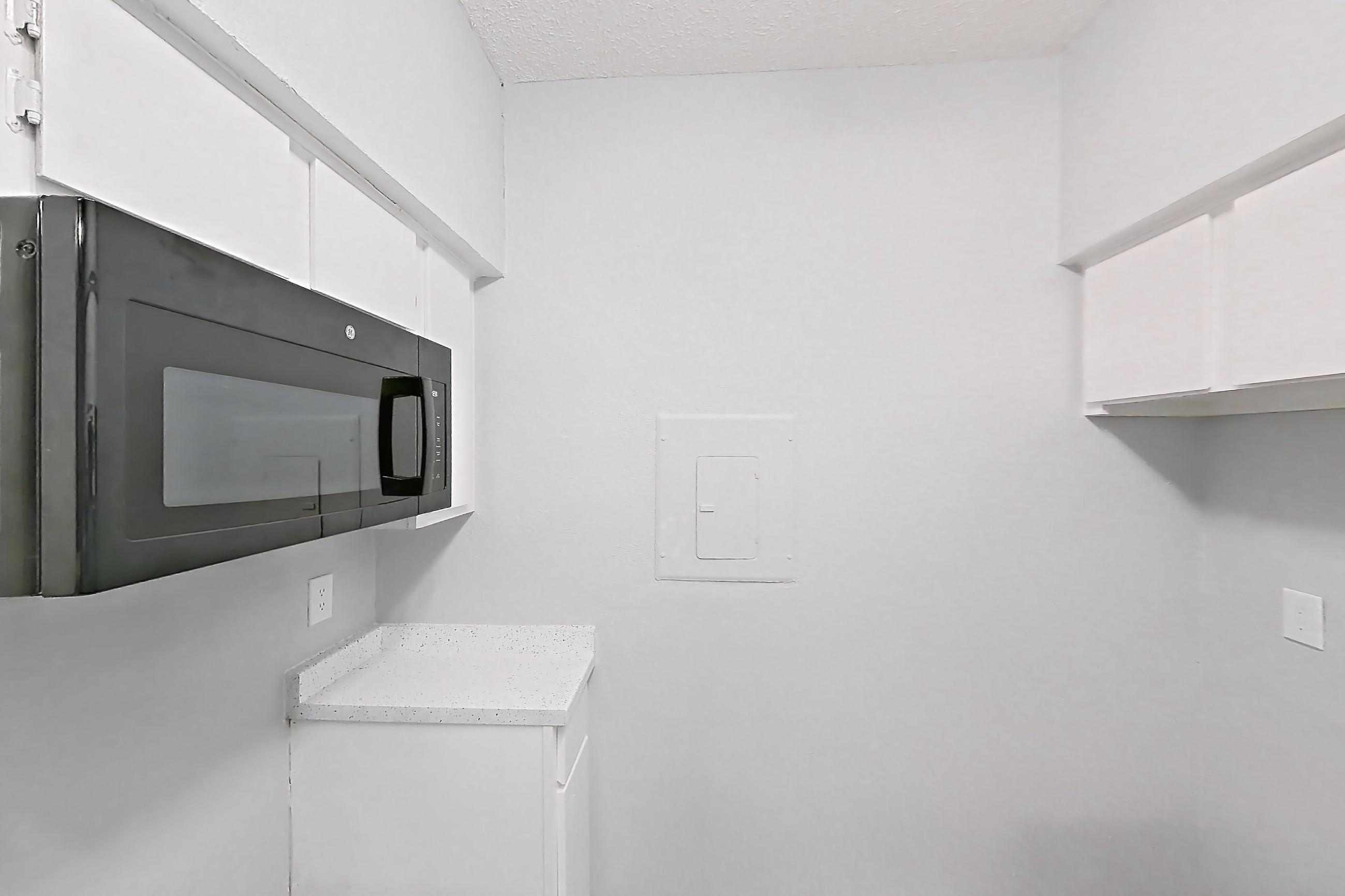 Kitchen with dark wood-finish flooring, Apartment 209 at The Griffin Apartments