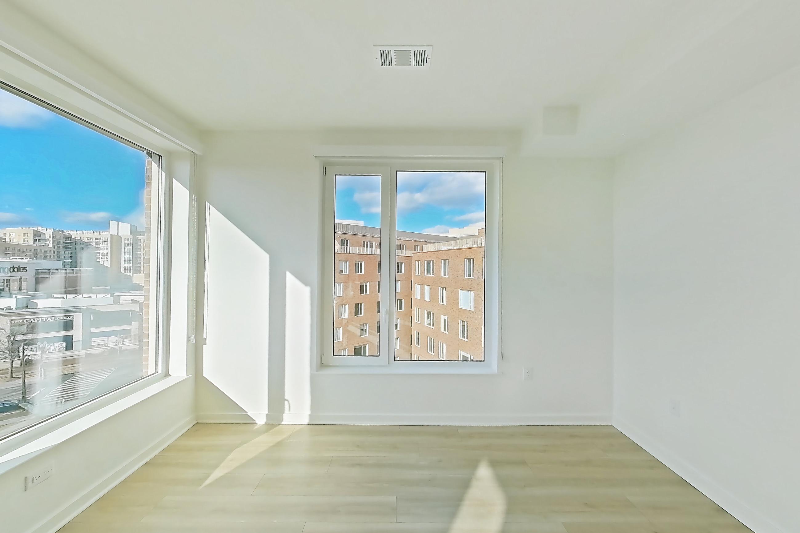 Living room with light wood-finish flooring, Apartment 657 at Residences at Mazza