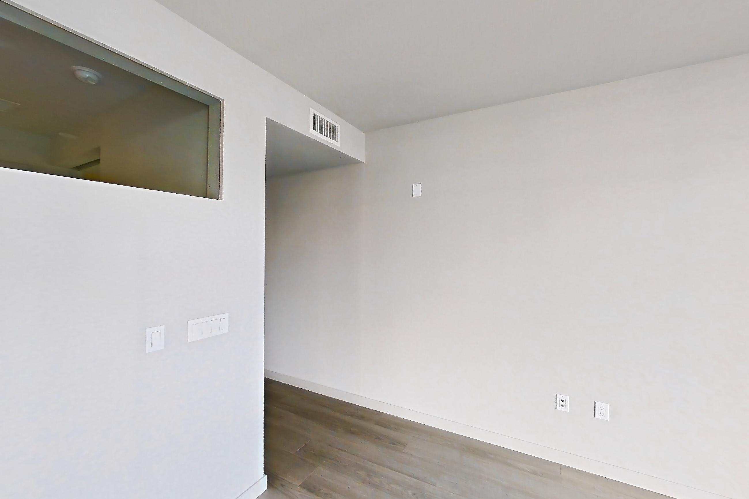 Living room with light wood-finish flooring, Apartment 0-3171 at Eighth and Grand