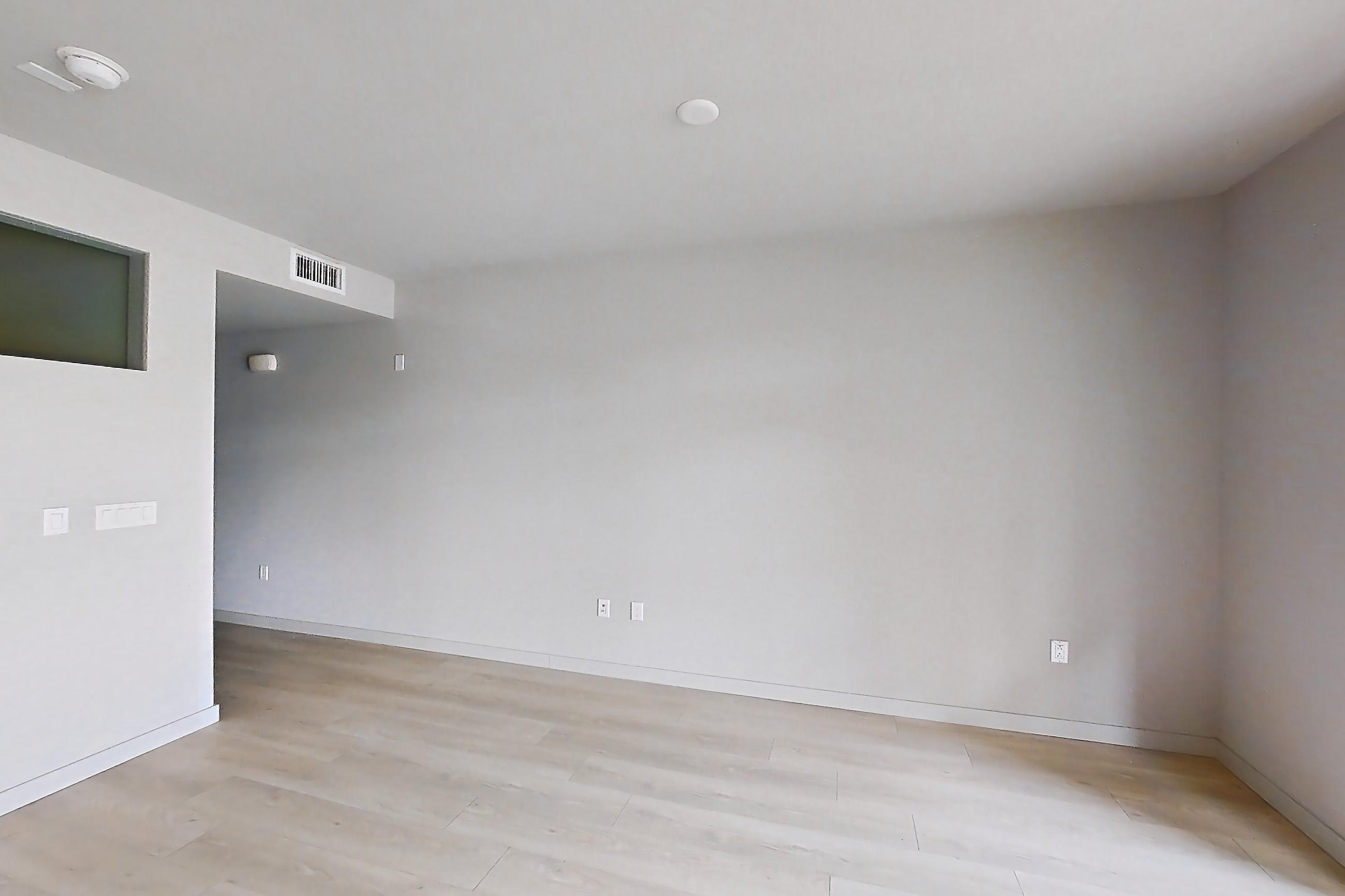 Kitchen with electric range, light countertops, light wood-finish flooring, microwave, oven/range, refrigerator, stainless steel appliances, and white appliances, Apartment 0-6137 at Eighth and Grand