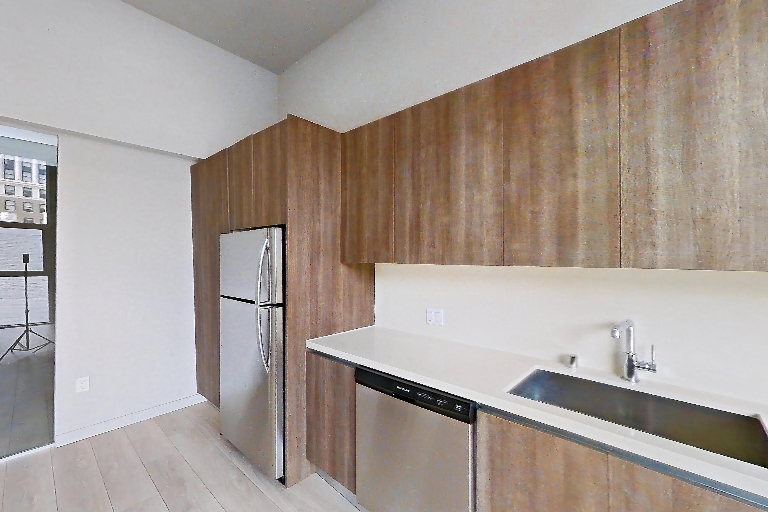 Kitchen with dishwasher, light stone countertops, light wood-finish flooring, and stainless steel appliances, Apartment 0-7071 at Eighth and Grand