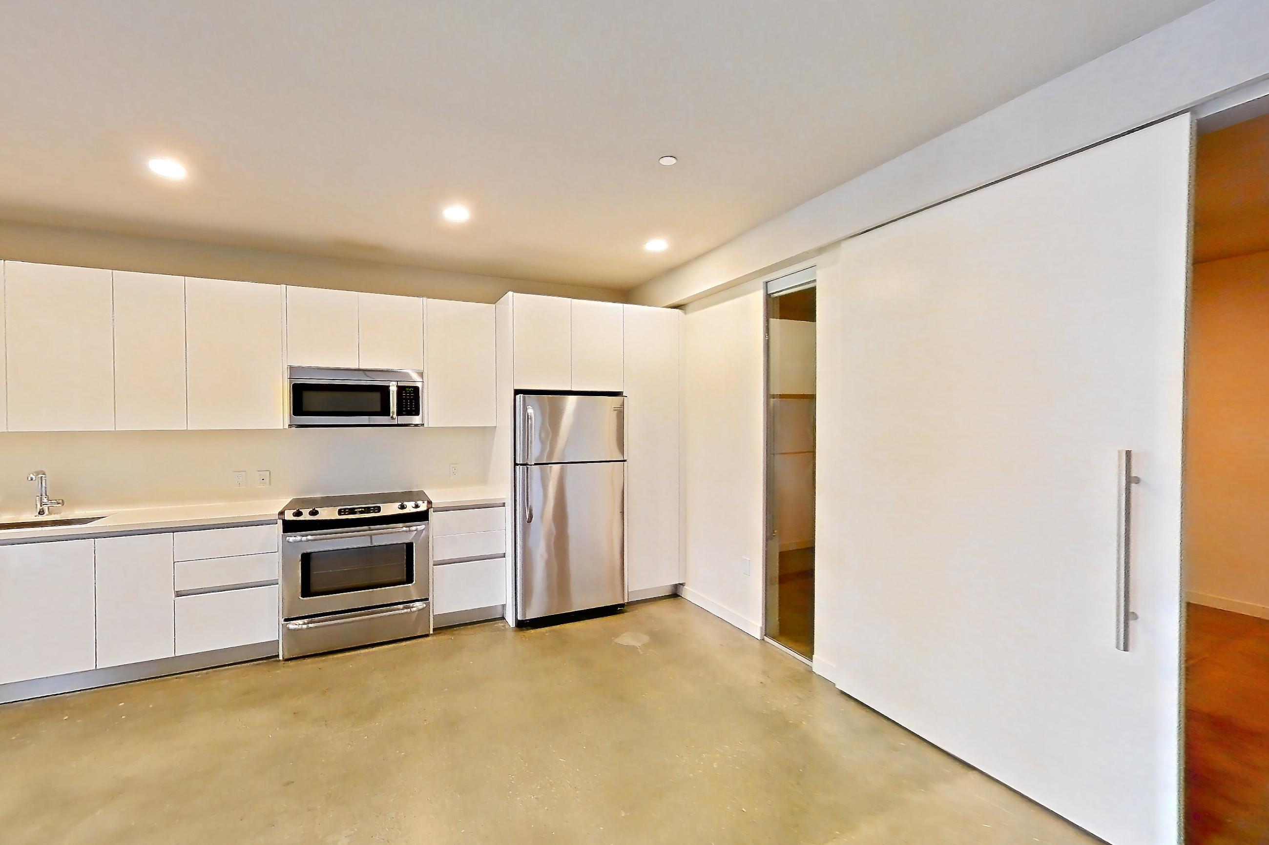 Living room with light concrete flooring and polished concrete flooring, Apartment 0-2086 at Eighth and Grand