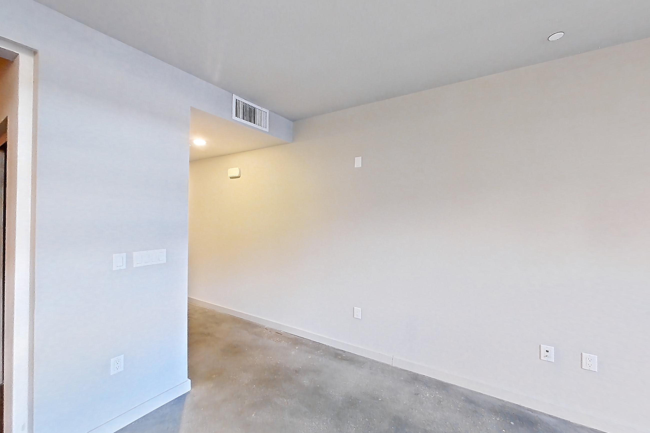 Living room with light concrete flooring and polished concrete flooring, Apartment 0-2086 at Eighth and Grand