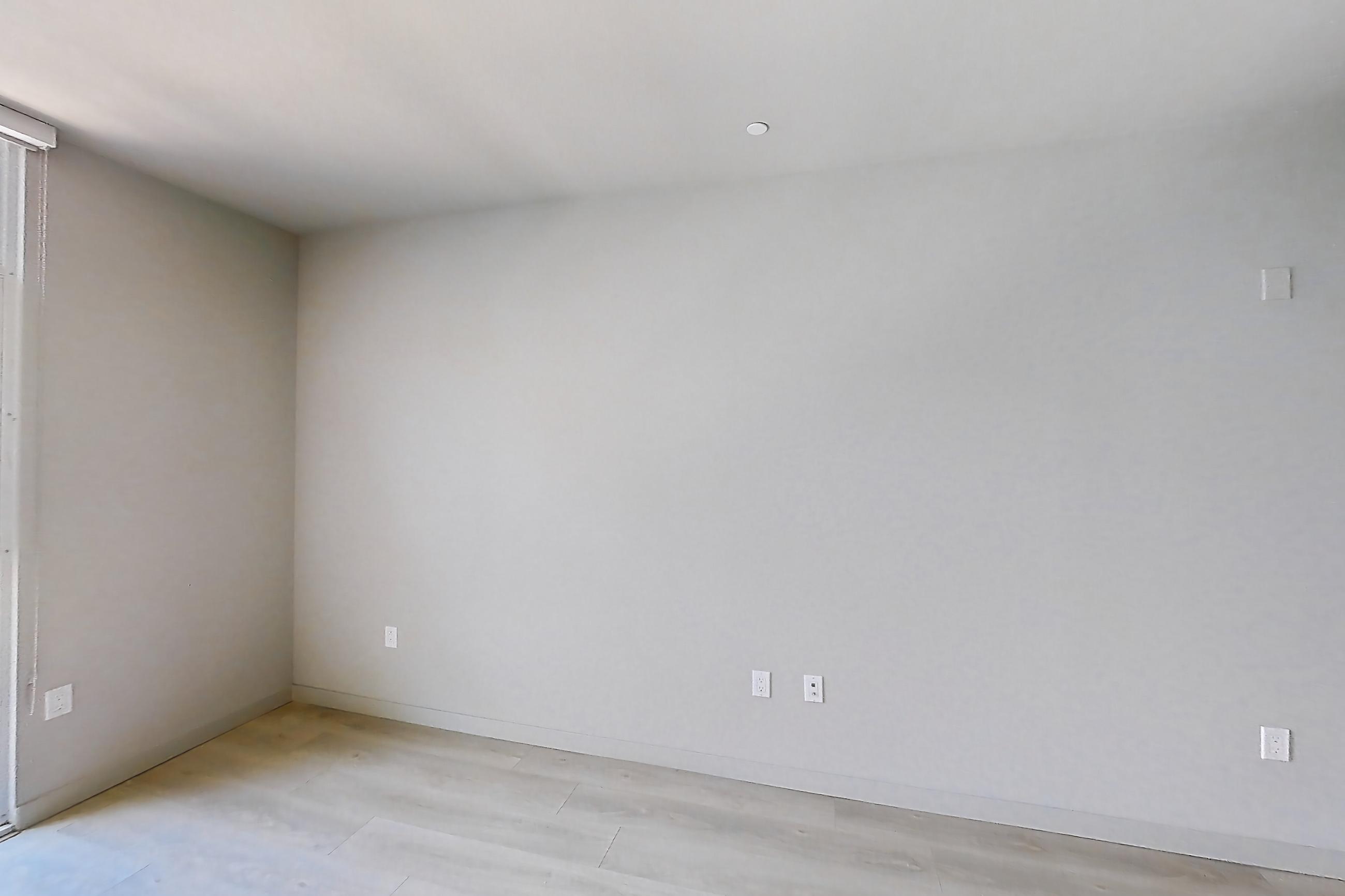 Living room with light wood-finish flooring, Apartment 0-5130 at Eighth and Grand