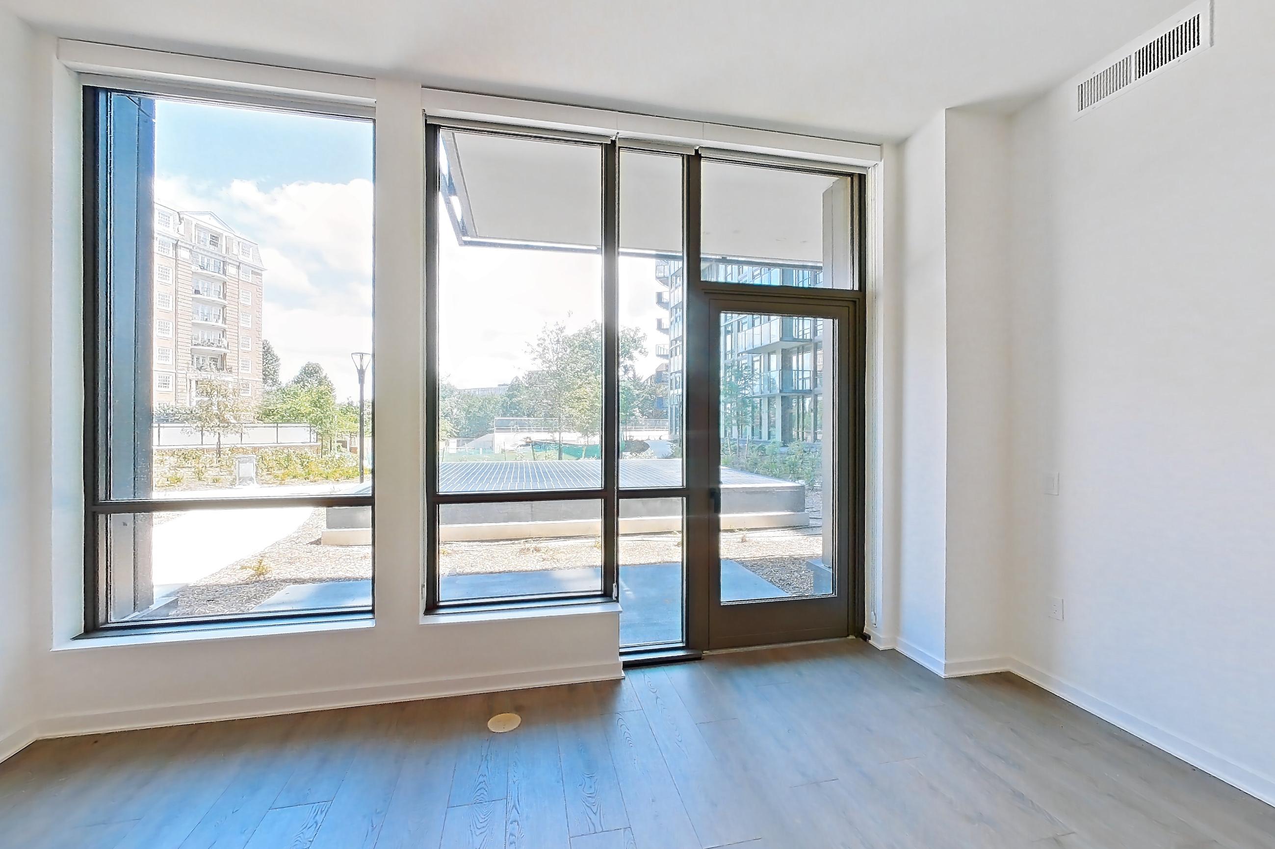 Living room with dark wood-finish flooring, Apartment 0119 at Aerie