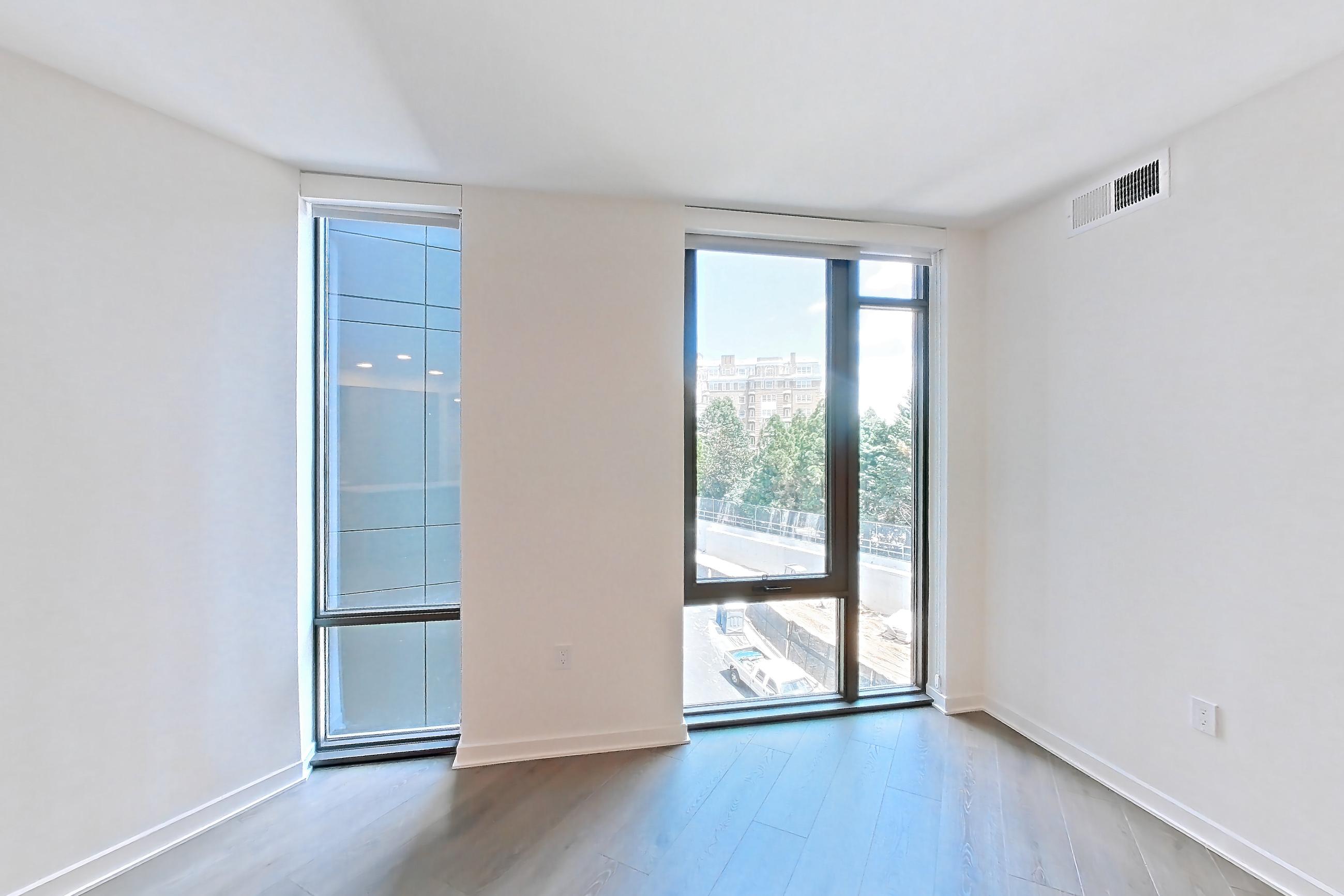 Living room with city view, light wood-finish flooring, wet bar, and wet/dry bar, Apartment 0310 at Aerie