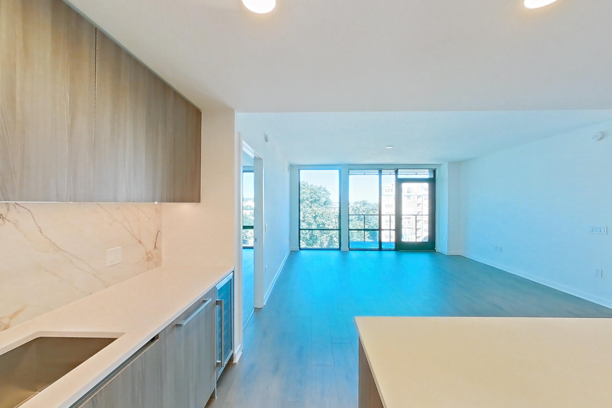 Kitchen with gas range, light stone countertops, light wood-finish flooring, oven/range, and stainless steel appliances, Apartment 0716 at Aerie