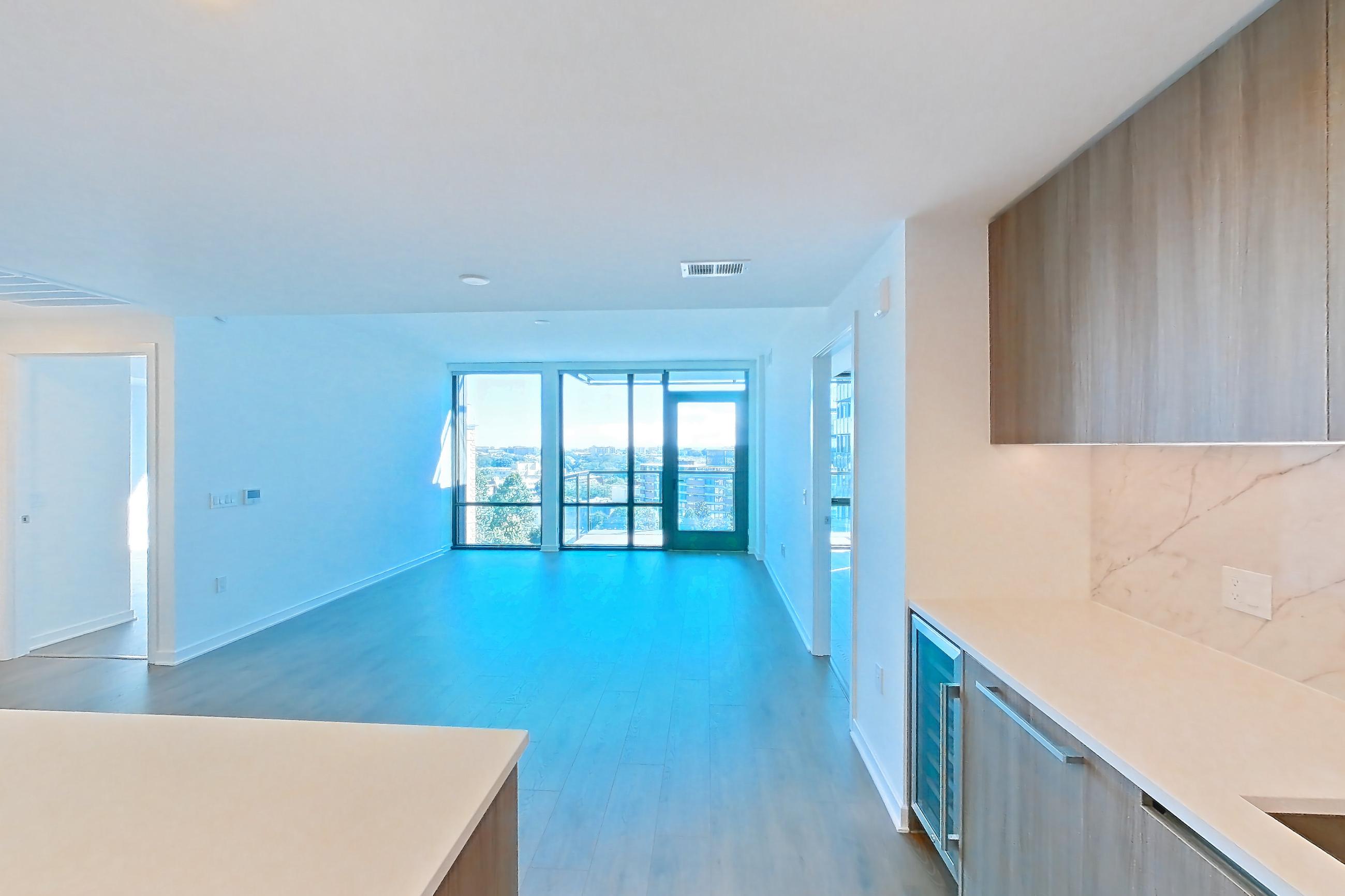 Kitchen with gas range, light stone countertops, light wood-finish flooring, oven/range, and stainless steel appliances, Apartment 0719 at Aerie