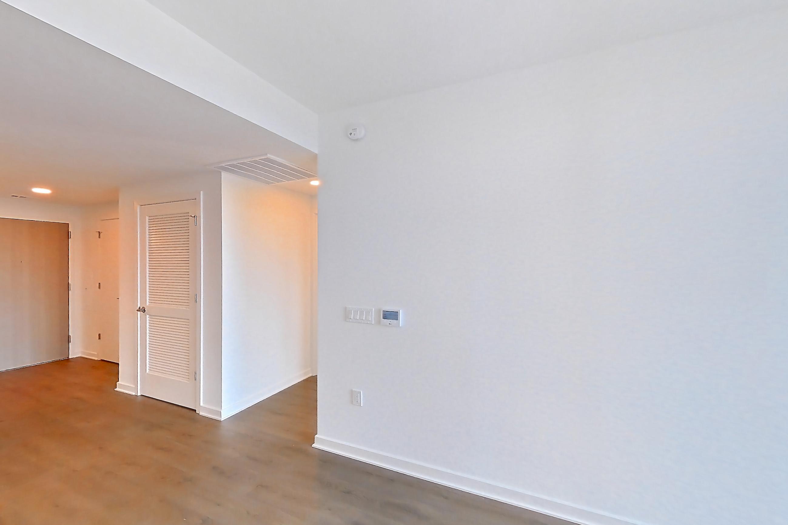 Living room with dark wood-finish flooring, Apartment 0719 at Aerie