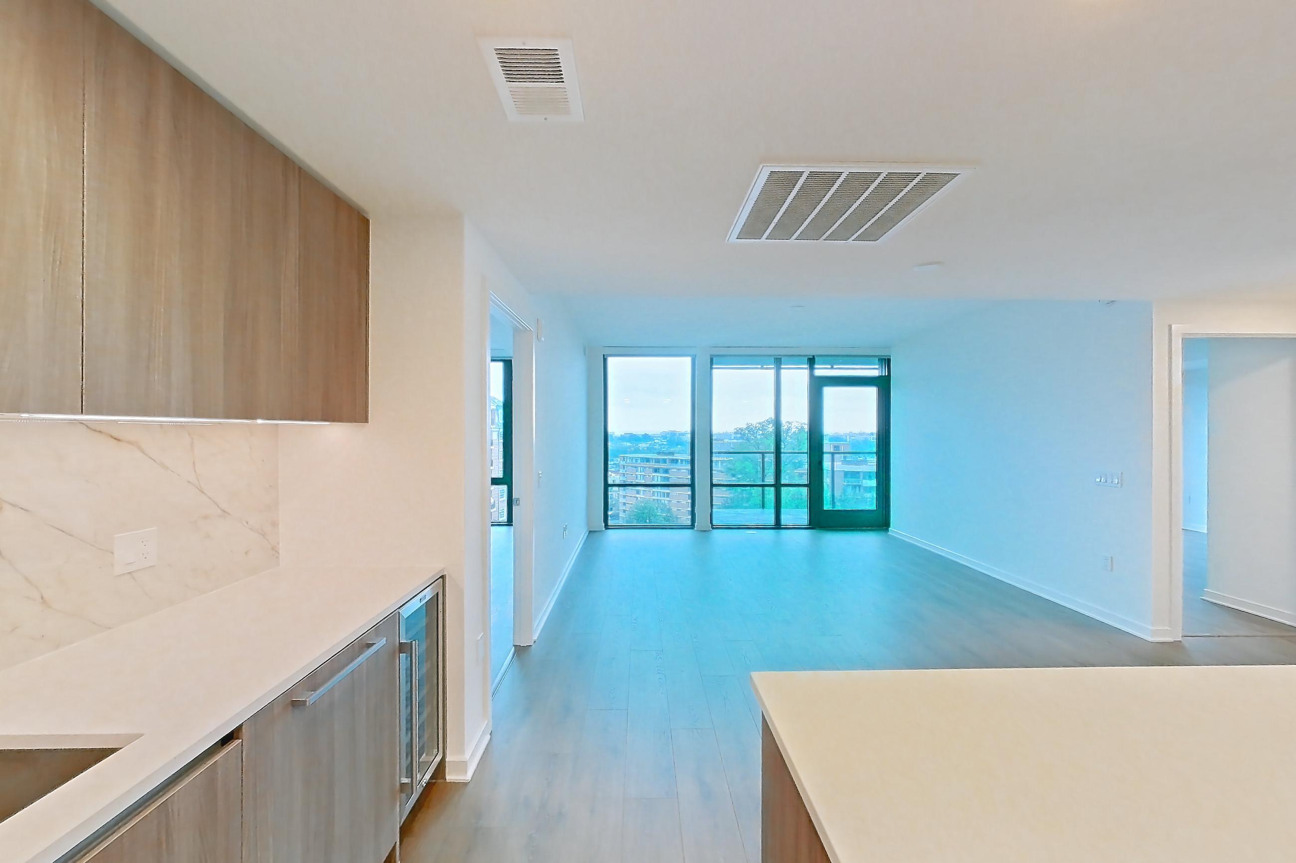 Kitchen with cooktop, light stone countertops, light wood-finish flooring, oven/range, and stainless steel appliances, Apartment 0820 at Aerie