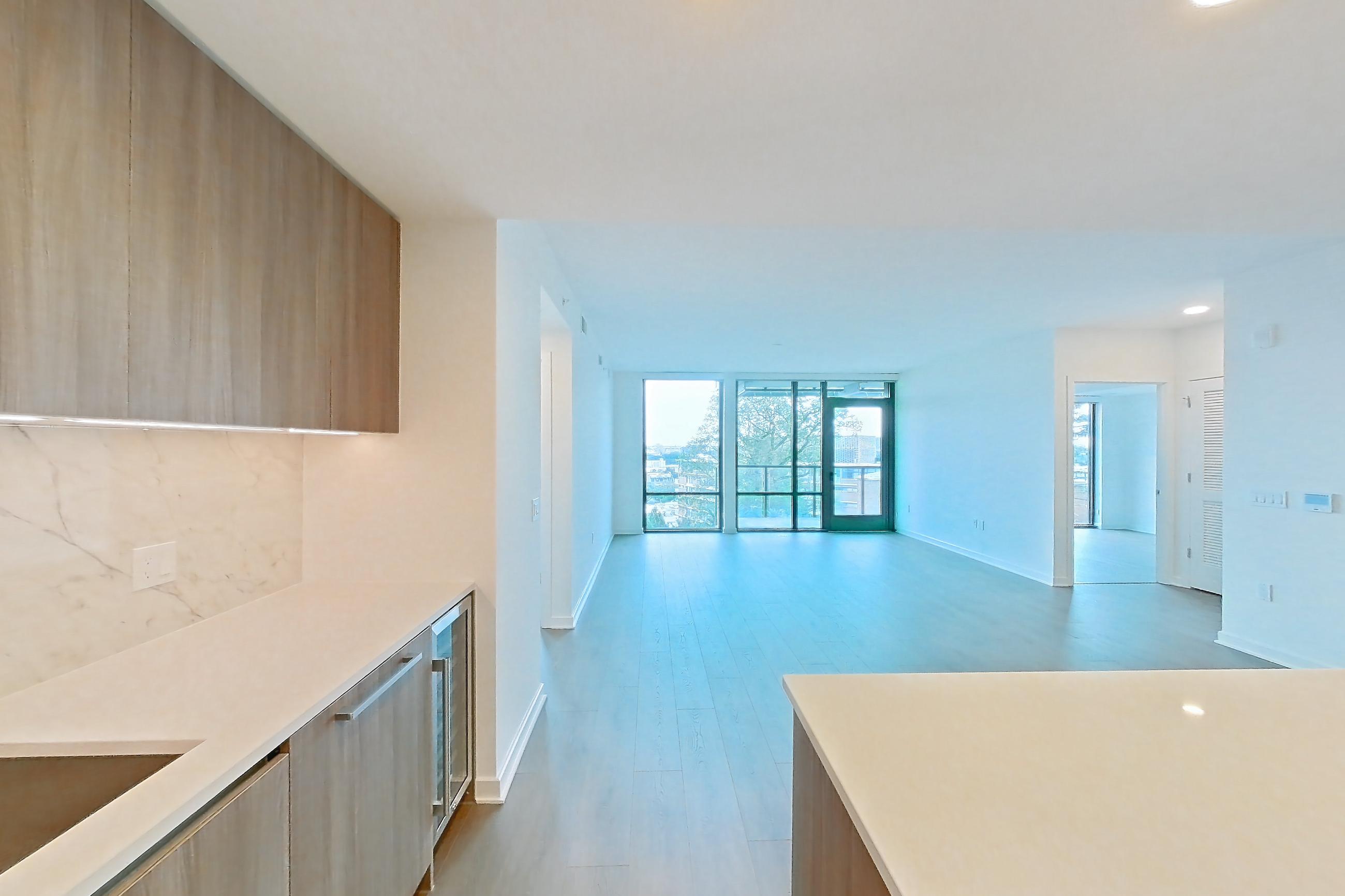 Kitchen with gas range, light stone countertops, light wood-finish flooring, oven/range, and stainless steel appliances, Apartment 0613 at Aerie