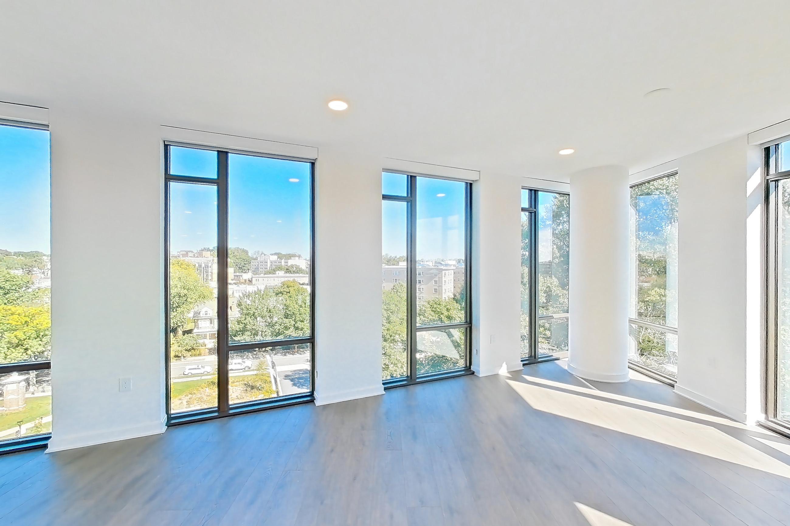 Living room with dark wood-finish flooring and wood-finish flooring, Apartment 0721 at Aerie