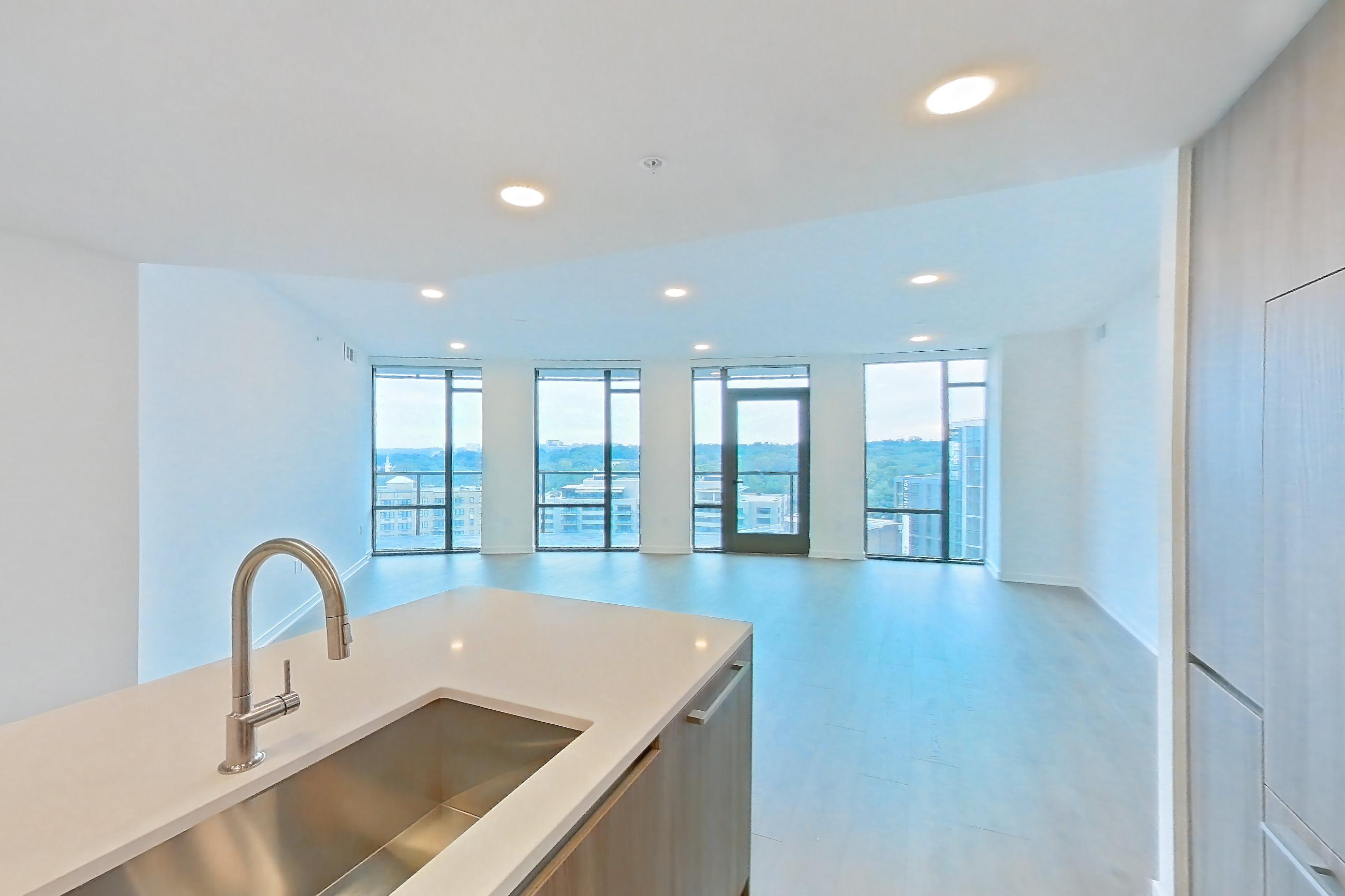 Kitchen with gas range, light stone countertops, light tile flooring, light wood-finish flooring, oven/range, and stainless steel appliances, Apartment 0804 at Aerie