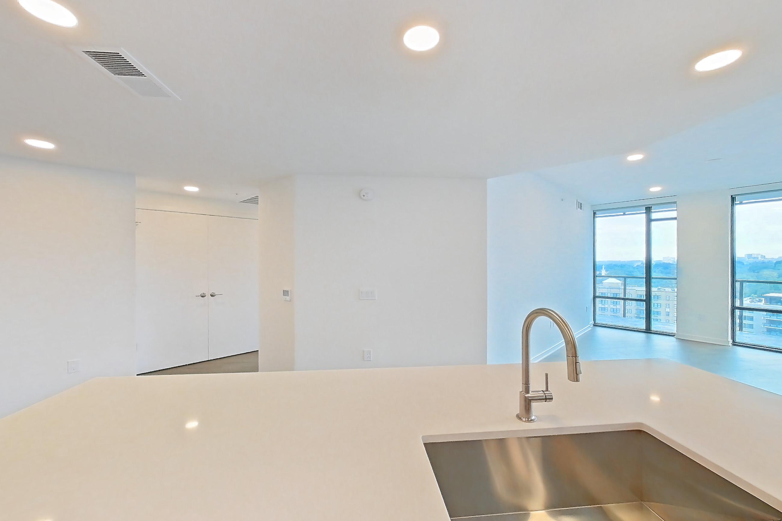 Kitchen with gas range, light stone countertops, light tile flooring, light wood-finish flooring, oven/range, and stainless steel appliances, Apartment 0804 at Aerie