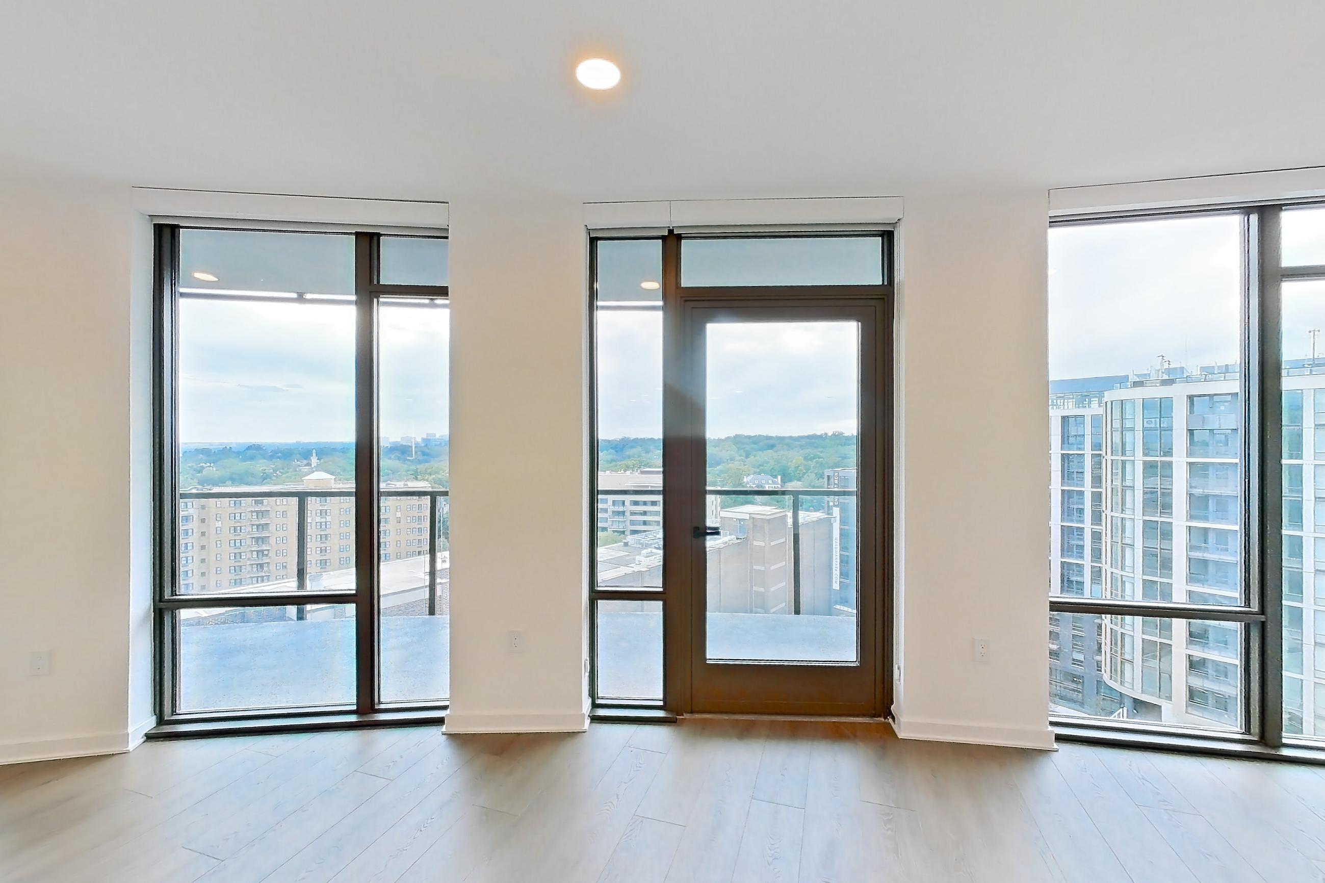 Living room with city view, light wood-finish flooring, and wood-finish flooring, Apartment 0804 at Aerie