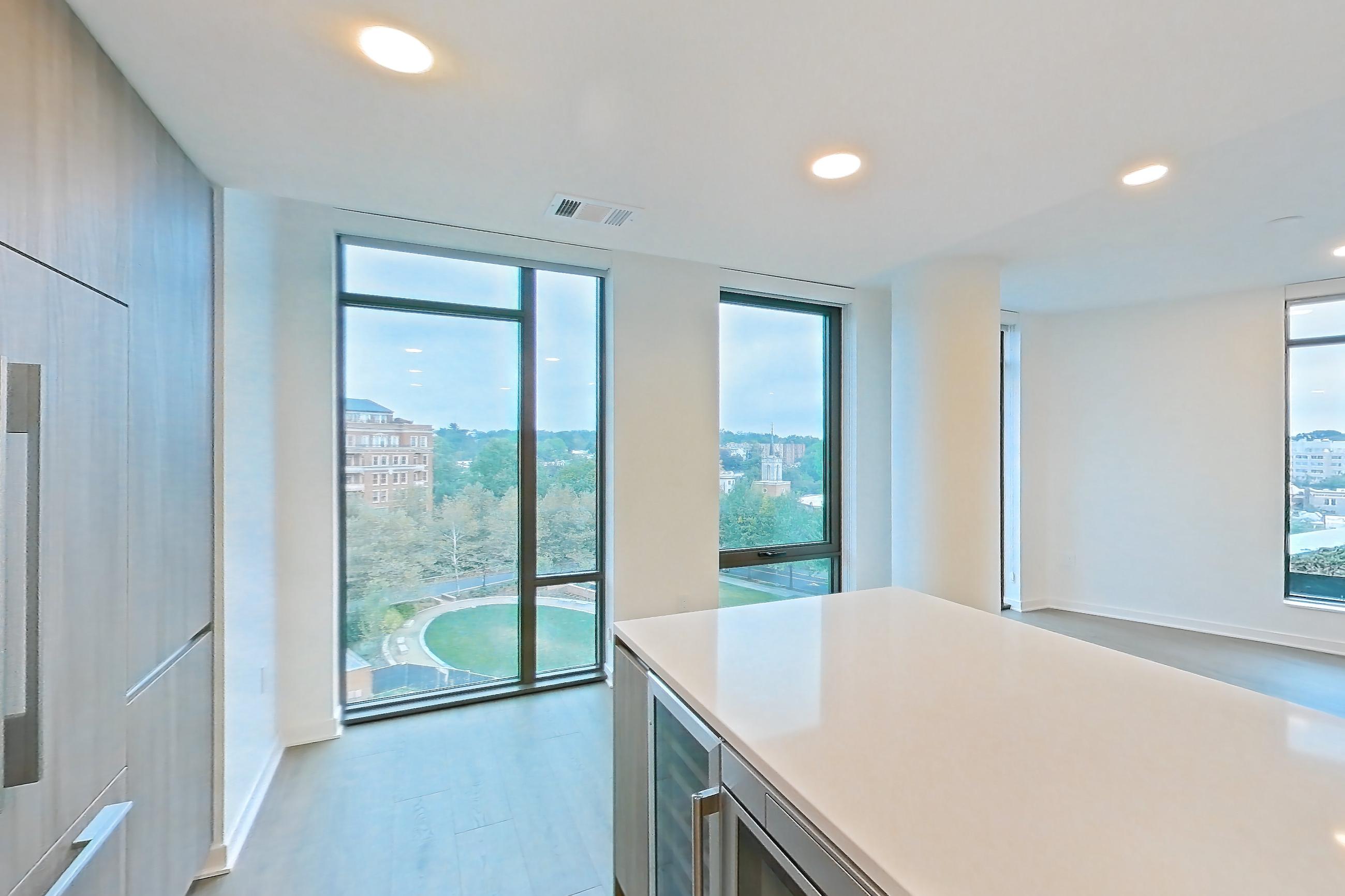 Kitchen with gas range, light stone countertops, light tile flooring, light wood-finish flooring, oven/range, and stainless steel appliances, Apartment 0822 at Aerie