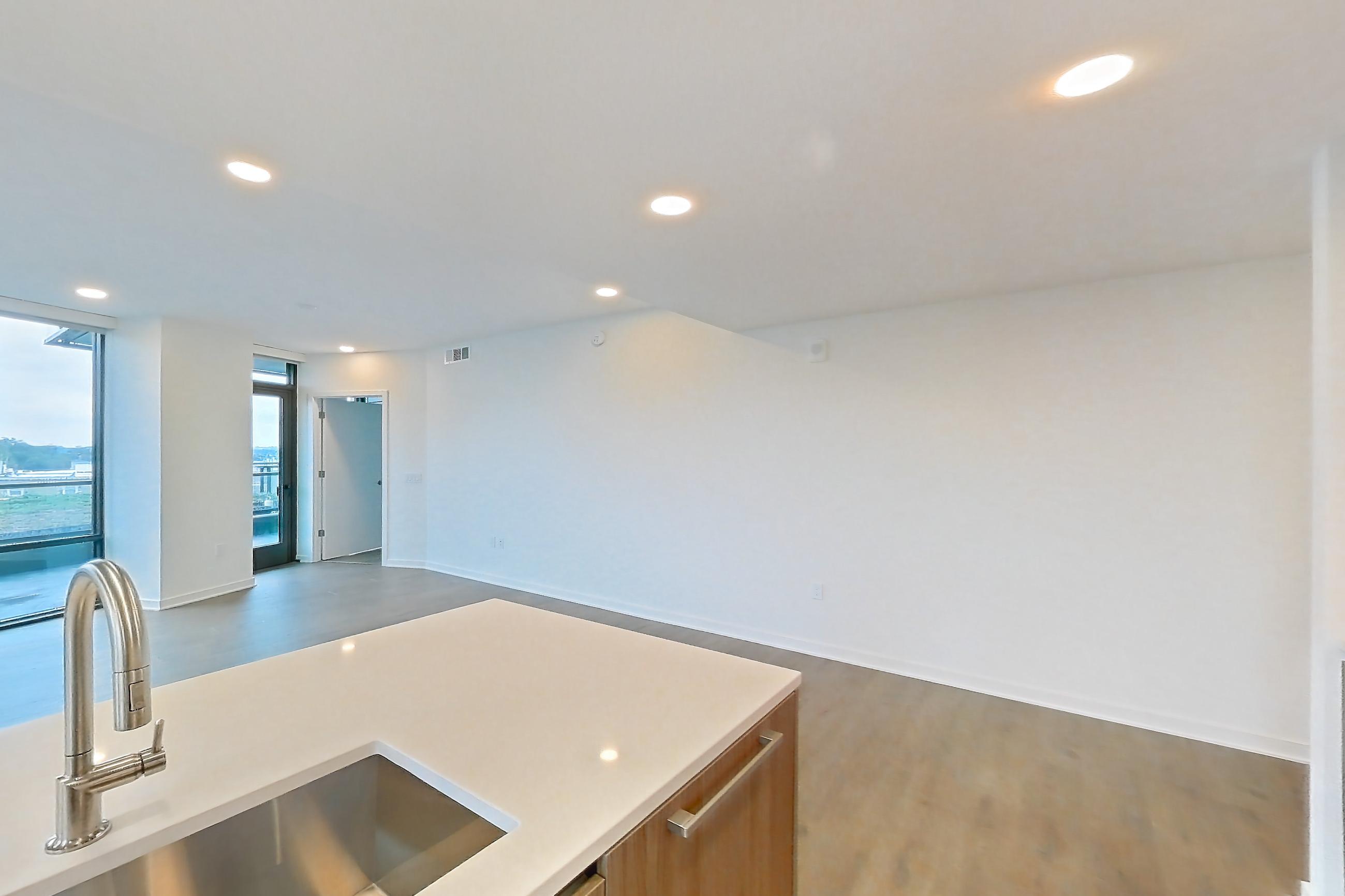 Kitchen with gas range, light stone countertops, light tile flooring, light wood-finish flooring, oven/range, and stainless steel appliances, Apartment 0822 at Aerie