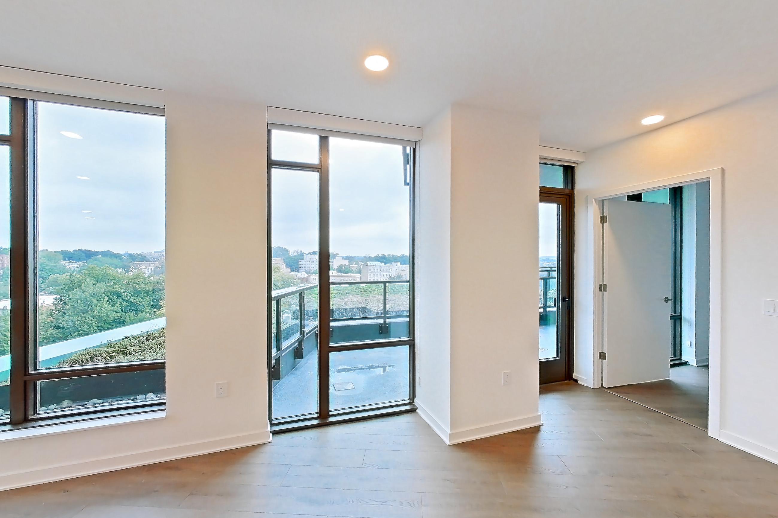 Living room with light wood-finish flooring and wood-finish flooring, Apartment 0822 at Aerie