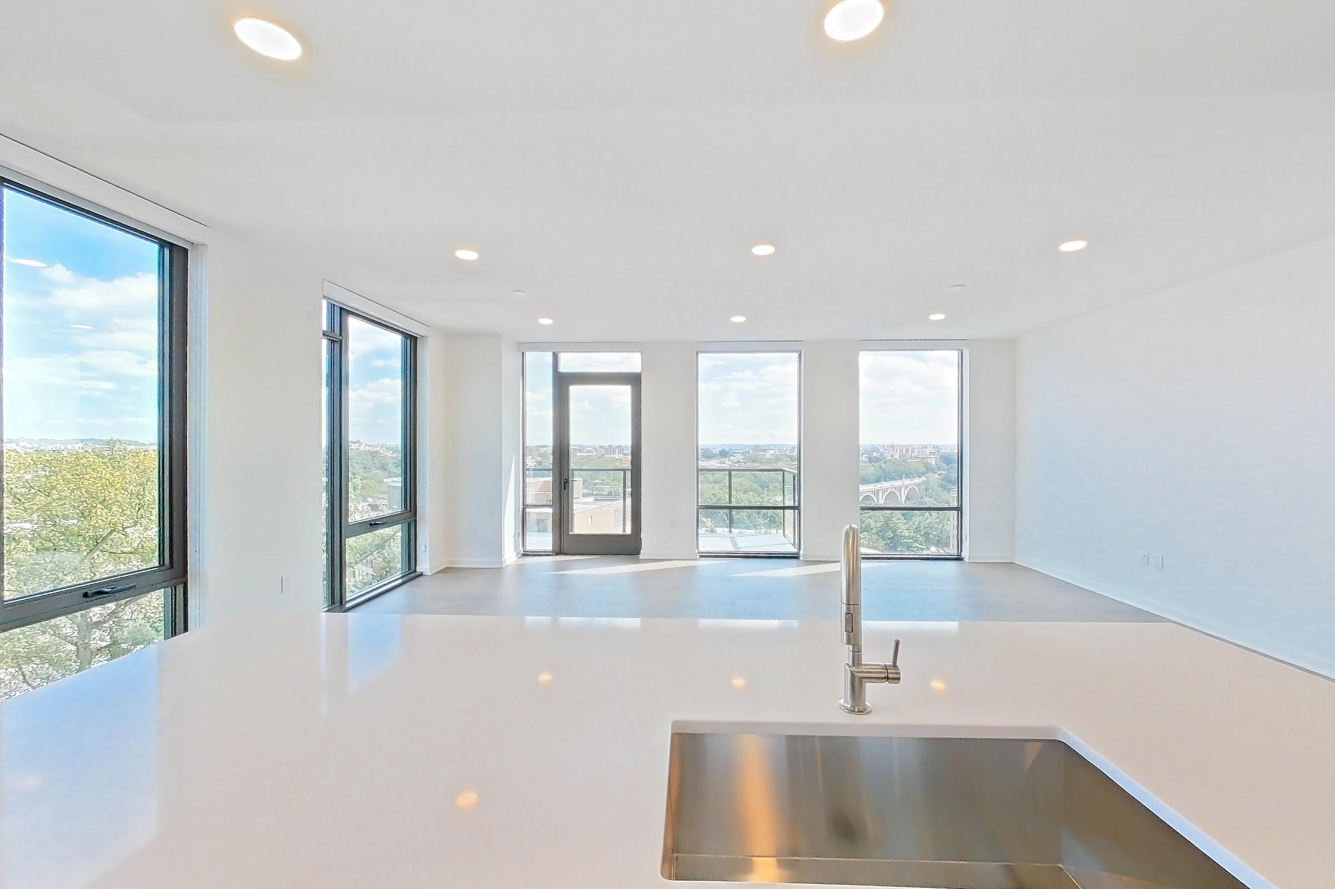 Kitchen with gas range, light stone countertops, light wood-finish flooring, oven/range, and stainless steel appliances, Apartment 0908 at Aerie