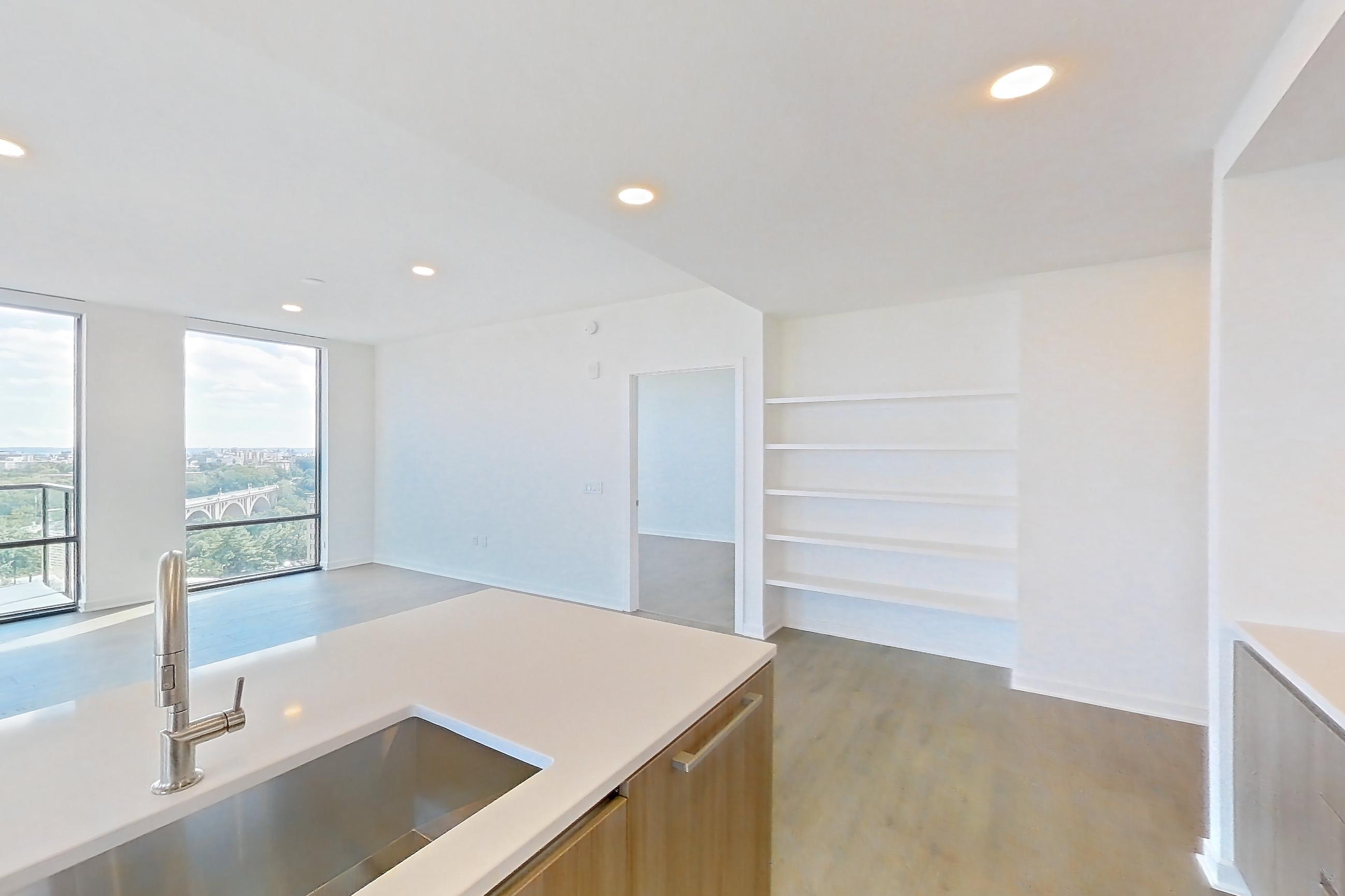 Kitchen with gas range, light stone countertops, light wood-finish flooring, oven/range, and stainless steel appliances, Apartment 0908 at Aerie