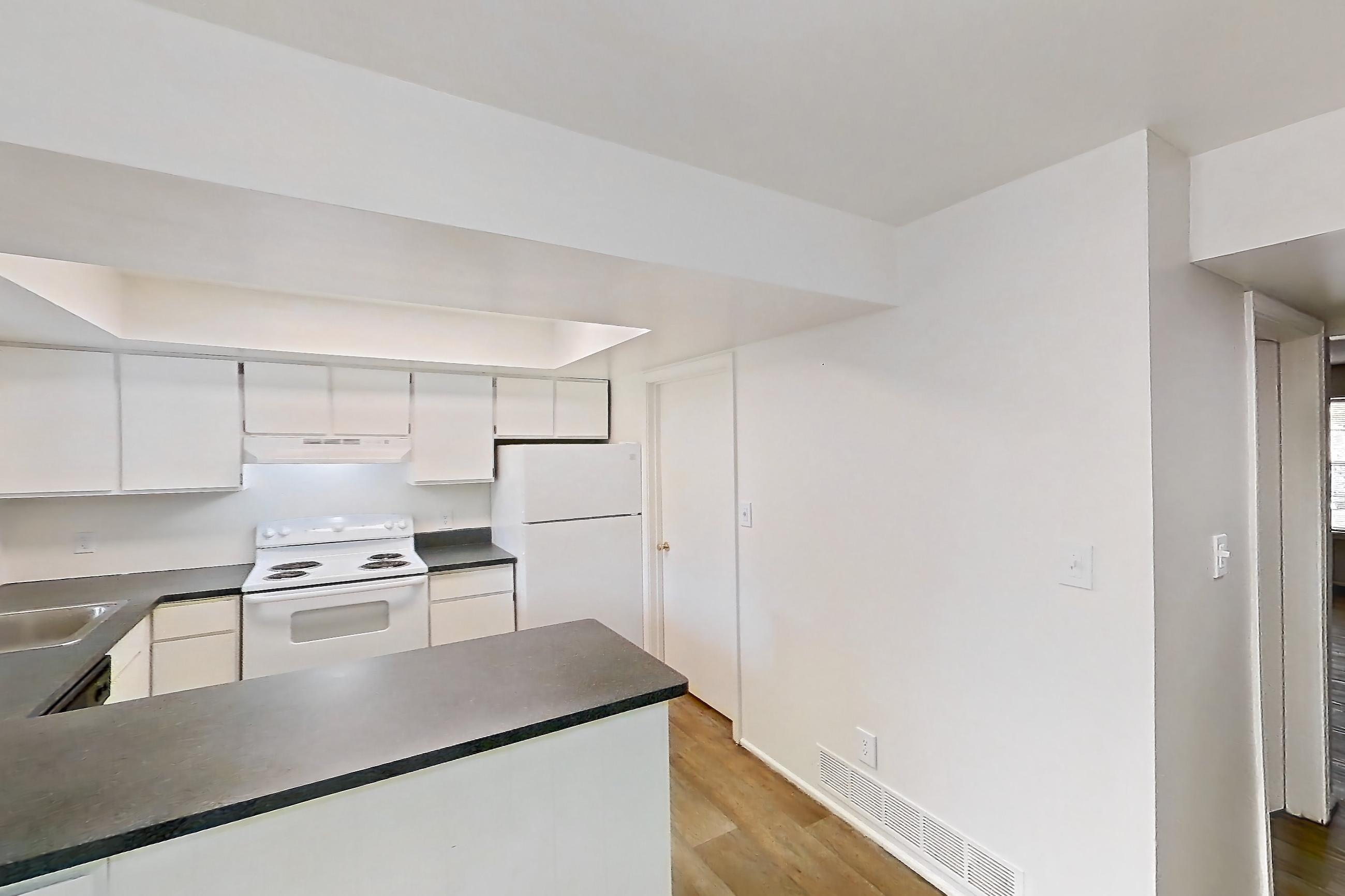 Dining room with dark countertops, electric range, oven/range, refrigerator, and white appliances, Apartment 5242ST at Canterbury Green
