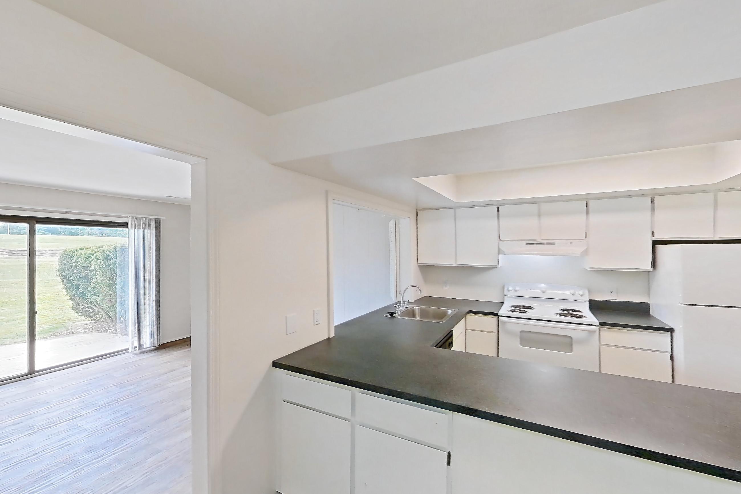 Dining room with dark countertops, electric range, oven/range, refrigerator, and white appliances, Apartment 5242ST at Canterbury Green