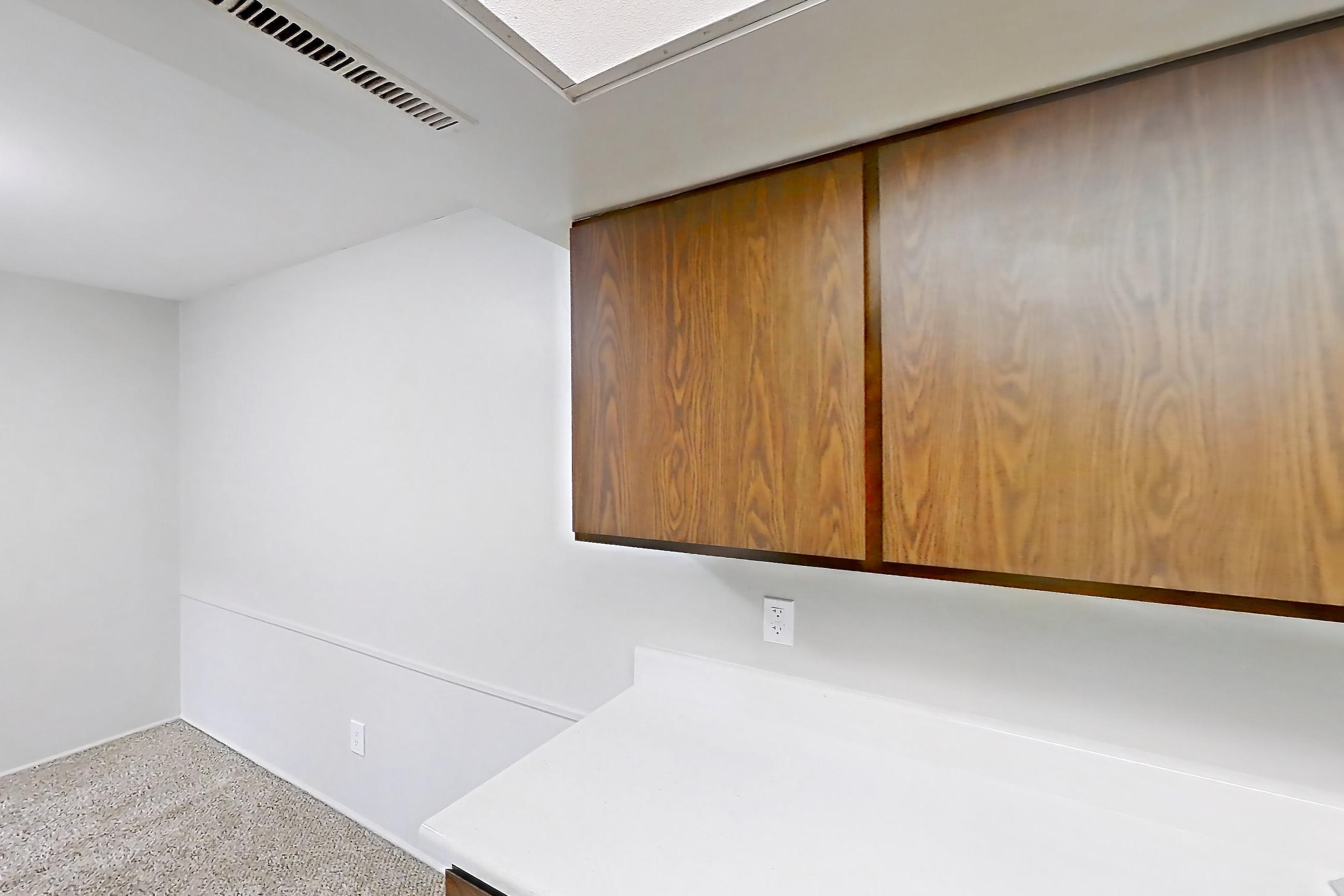 Kitchen with black appliances, dishwasher, light countertops, light wood-finish flooring, oven/range, and refrigerator, Apartment 2834-4NO at Canterbury Green
