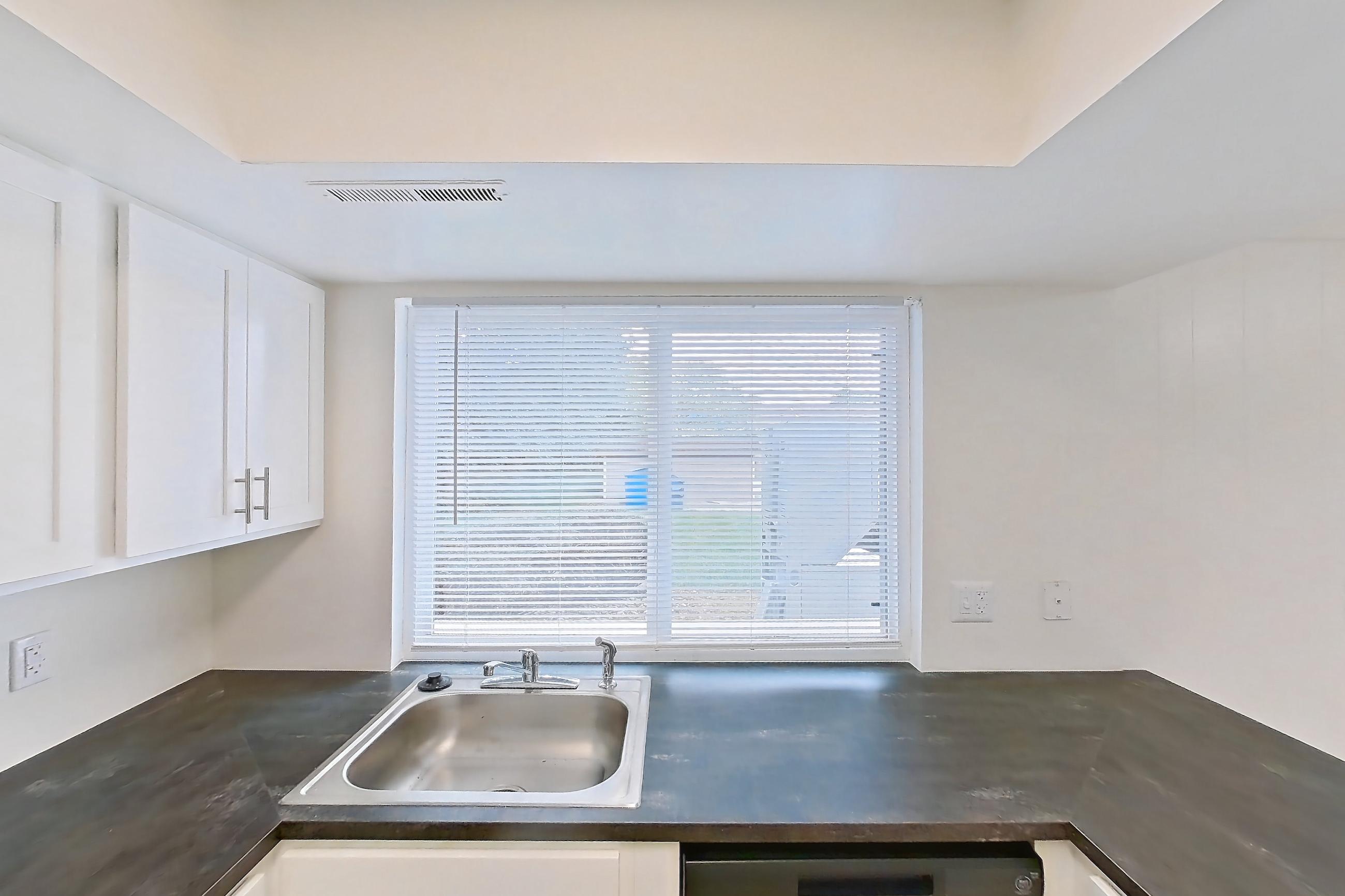 Kitchen with black appliances, dark countertops, electric range, light wood-finish flooring, and oven/range, Apartment 2924CA at Canterbury Green