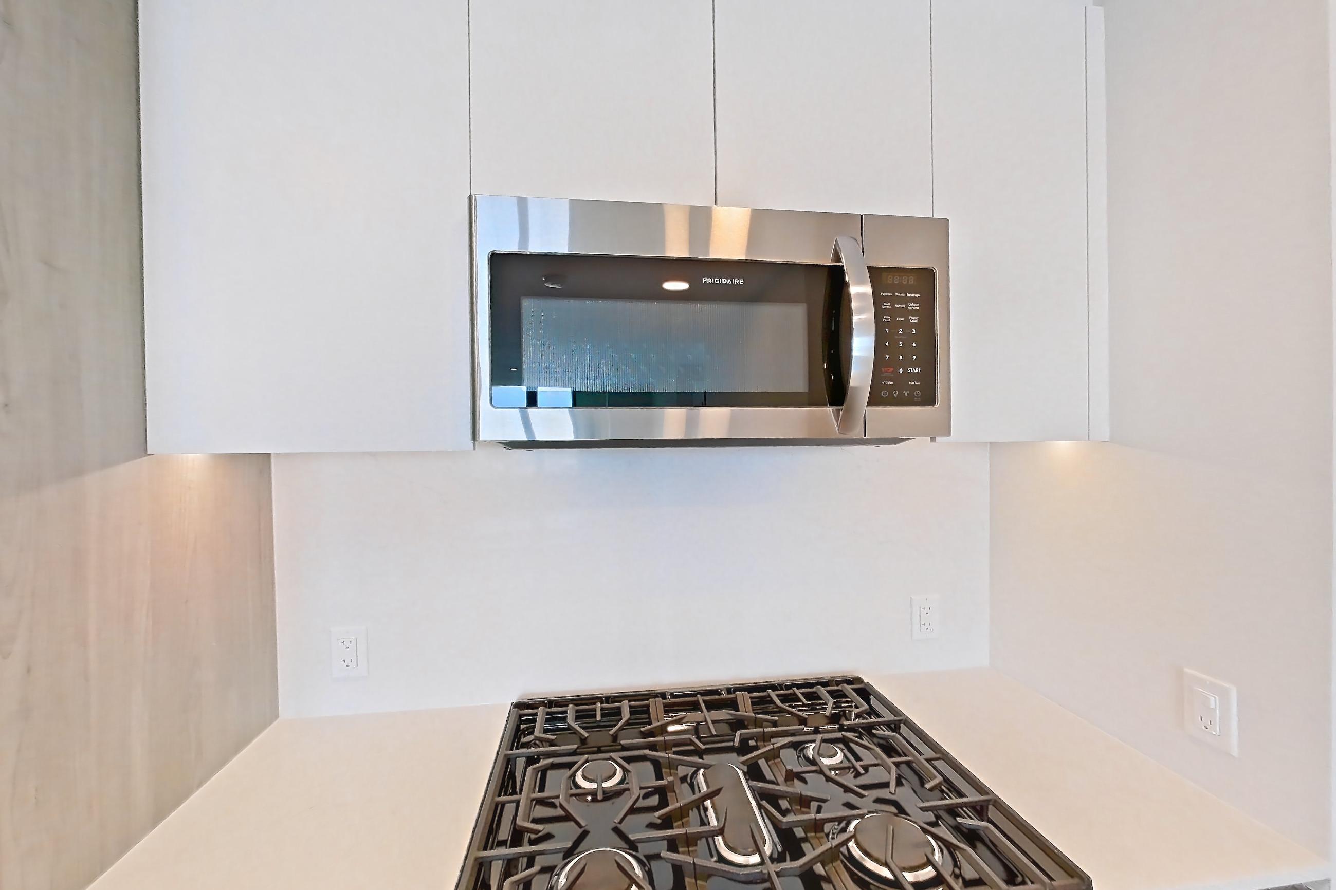 Kitchen with gas range, light wood-finish flooring, oven/range, and stainless steel appliances, Apartment 917 at Loden