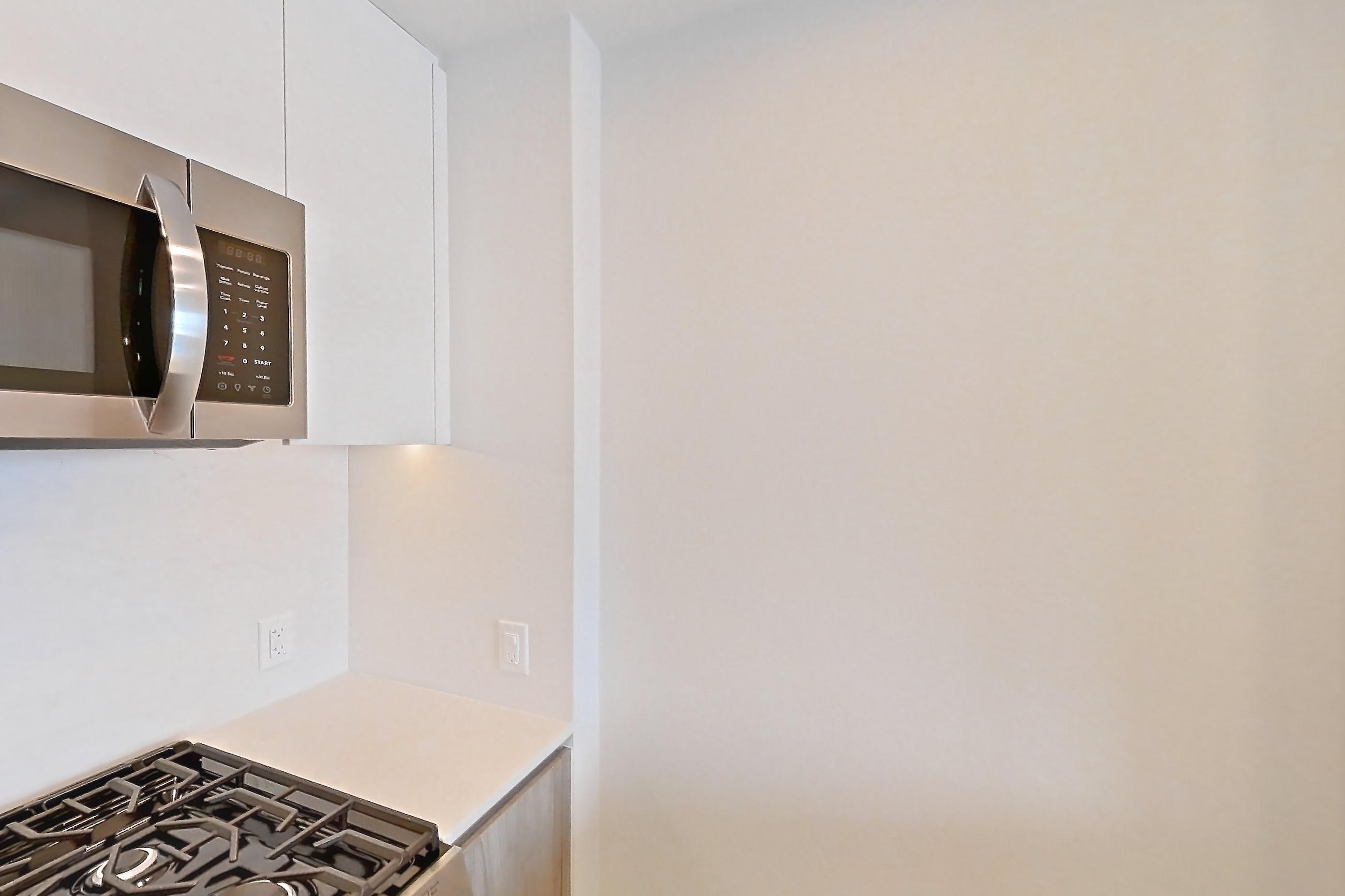 Kitchen with gas range, light wood-finish flooring, oven/range, and stainless steel appliances, Apartment 917 at Loden