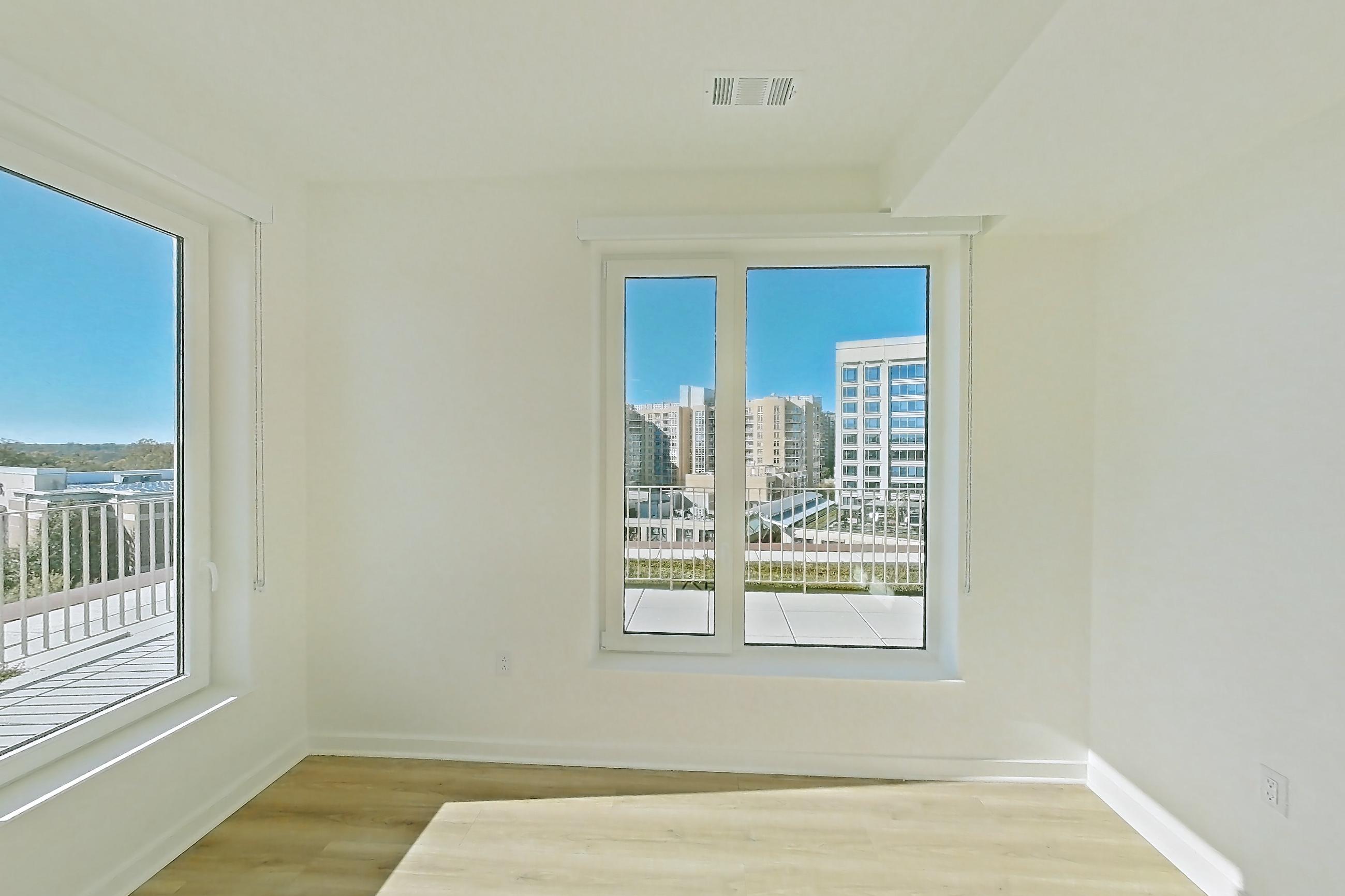 Living room with light wood-finish flooring, Apartment PH11 at Residences at Mazza