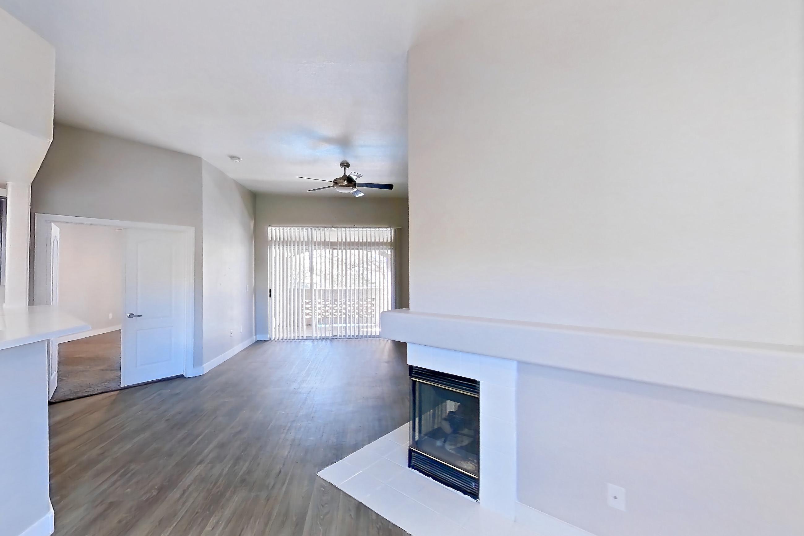 Dining room with fireplace, light wood-finish flooring, and tile fireplace, Apartment 2030 at Monaco Park