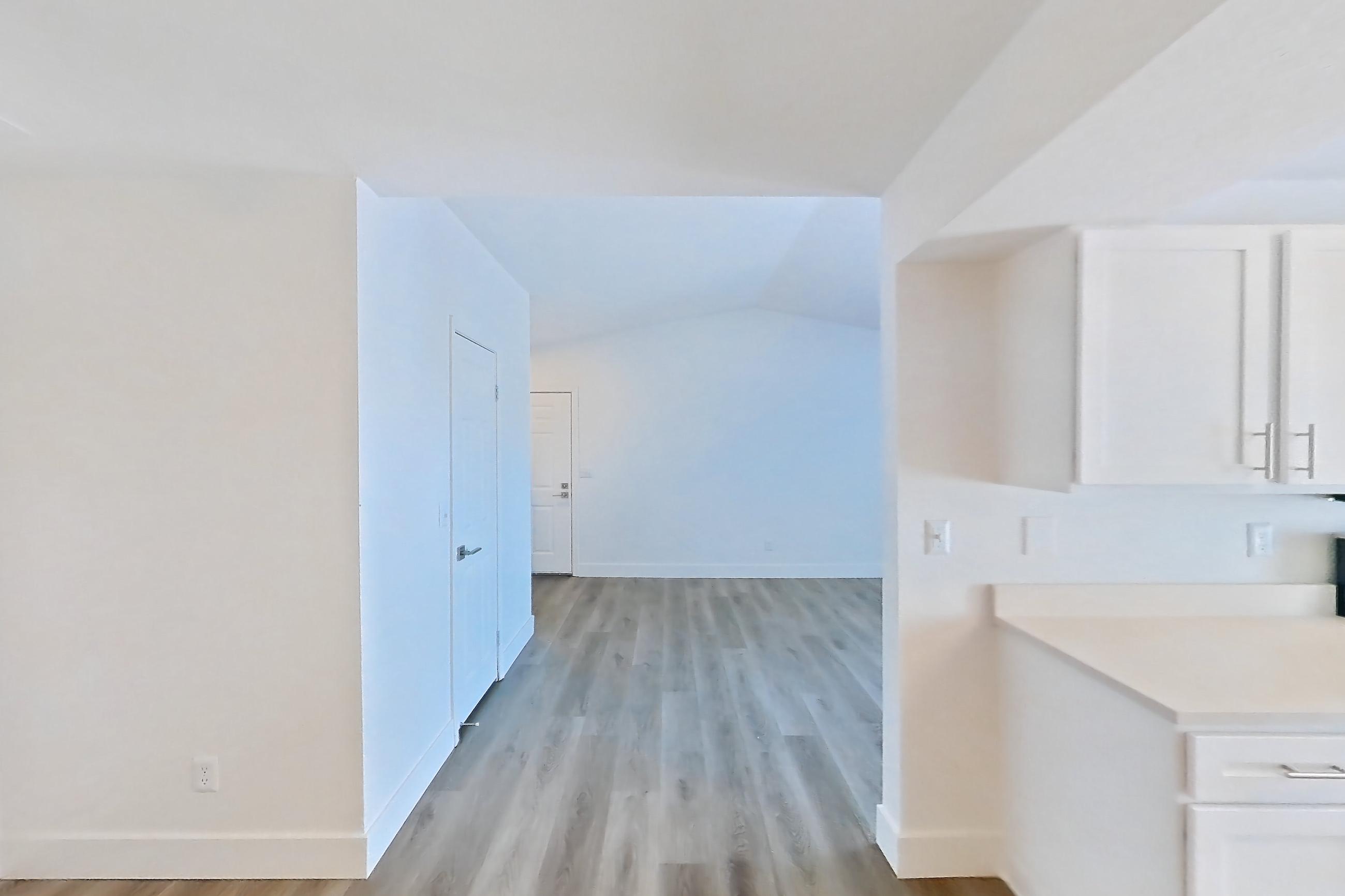 Dining room with electric range, light countertops, light wood-finish flooring, oven/range, and stainless steel appliances, Apartment 34-2089 at Xander 3900