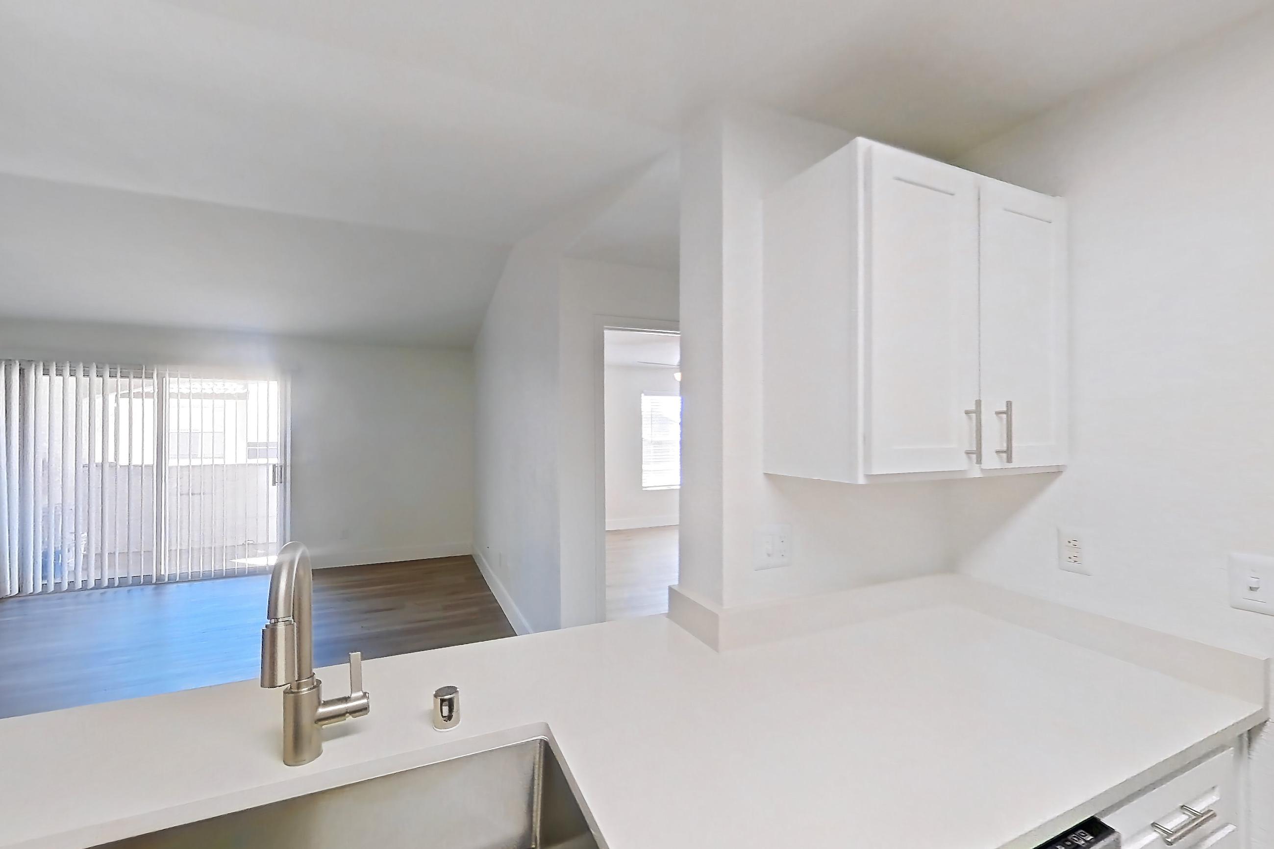 Kitchen with dishwasher, electric range, light countertops, light wood-finish flooring, microwave, oven/range, refrigerator, and stainless steel appliances, Apartment 30-2083 at Xander 3900