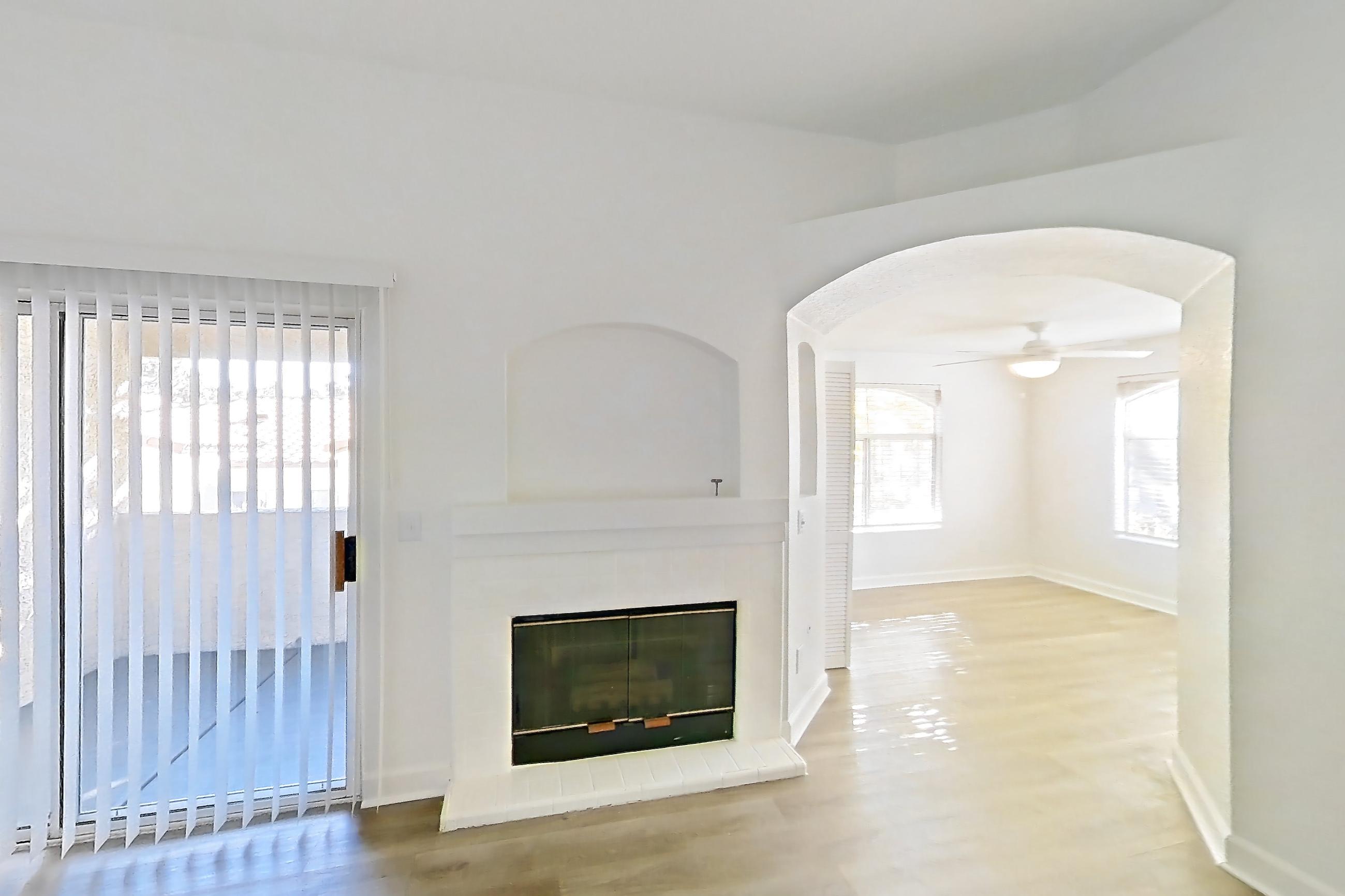 Living room with fireplace and light wood-finish flooring, Apartment 2110 at Vintage Pointe