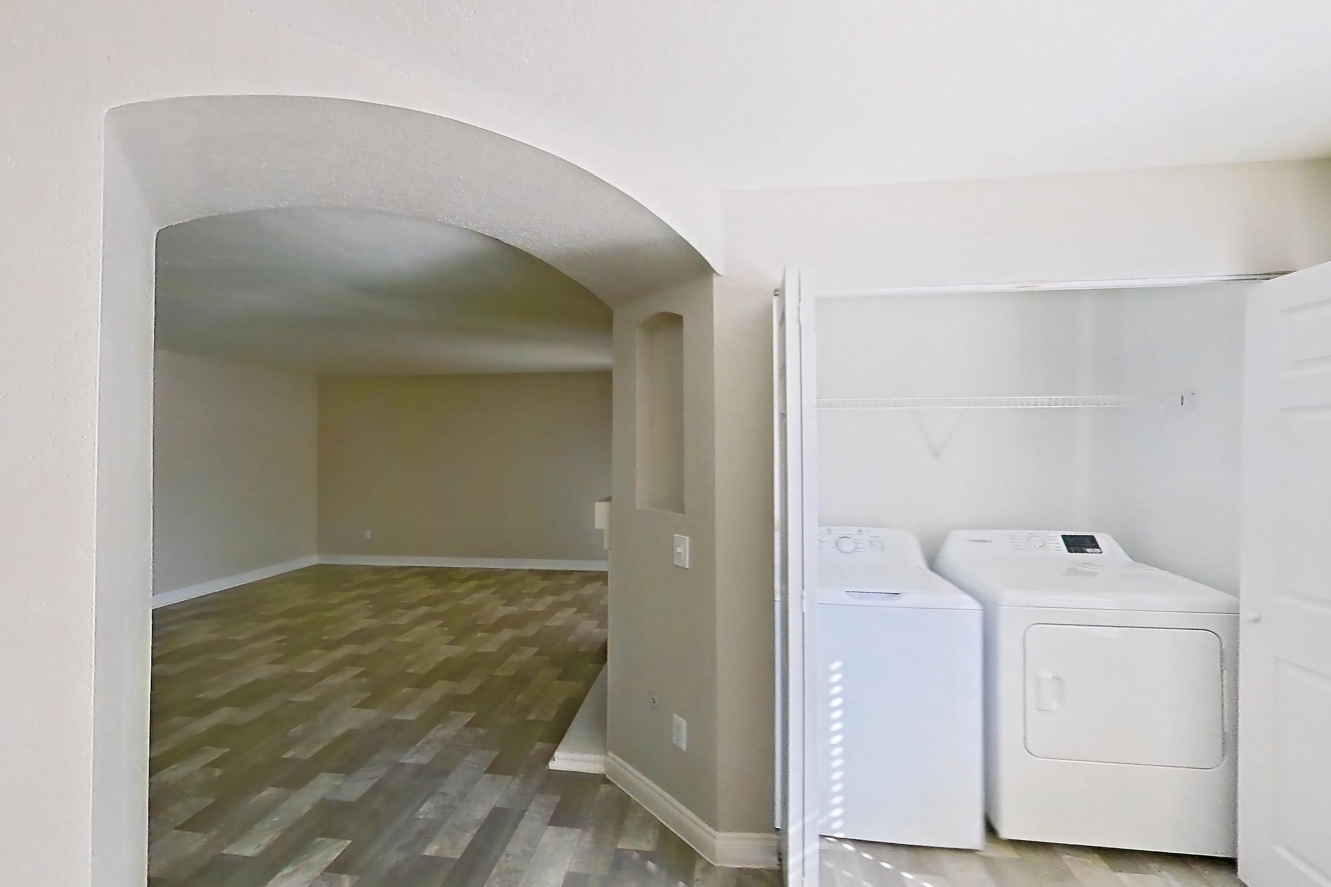 Dining room with in-unit laundry and light wood-finish flooring, Apartment 1018 at Vintage Pointe