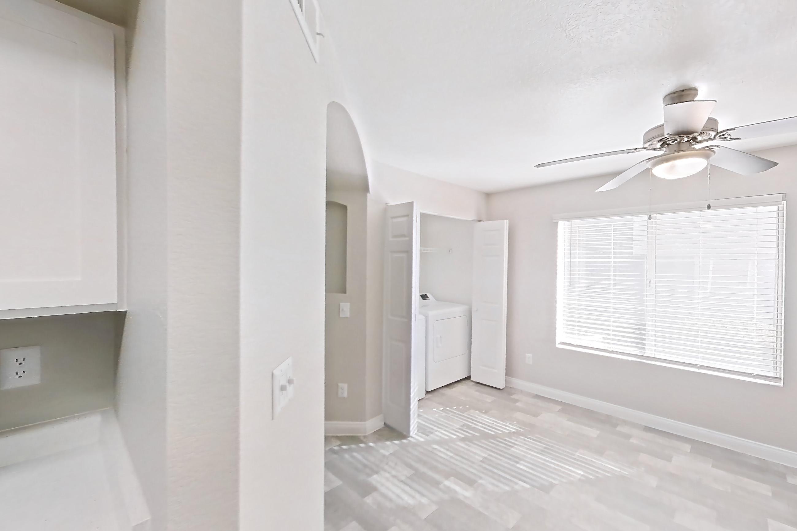 Kitchen with gas range, in-unit laundry, light countertops, light wood-finish flooring, microwave, oven/range, refrigerator, and stainless steel appliances, Apartment 1018 at Vintage Pointe
